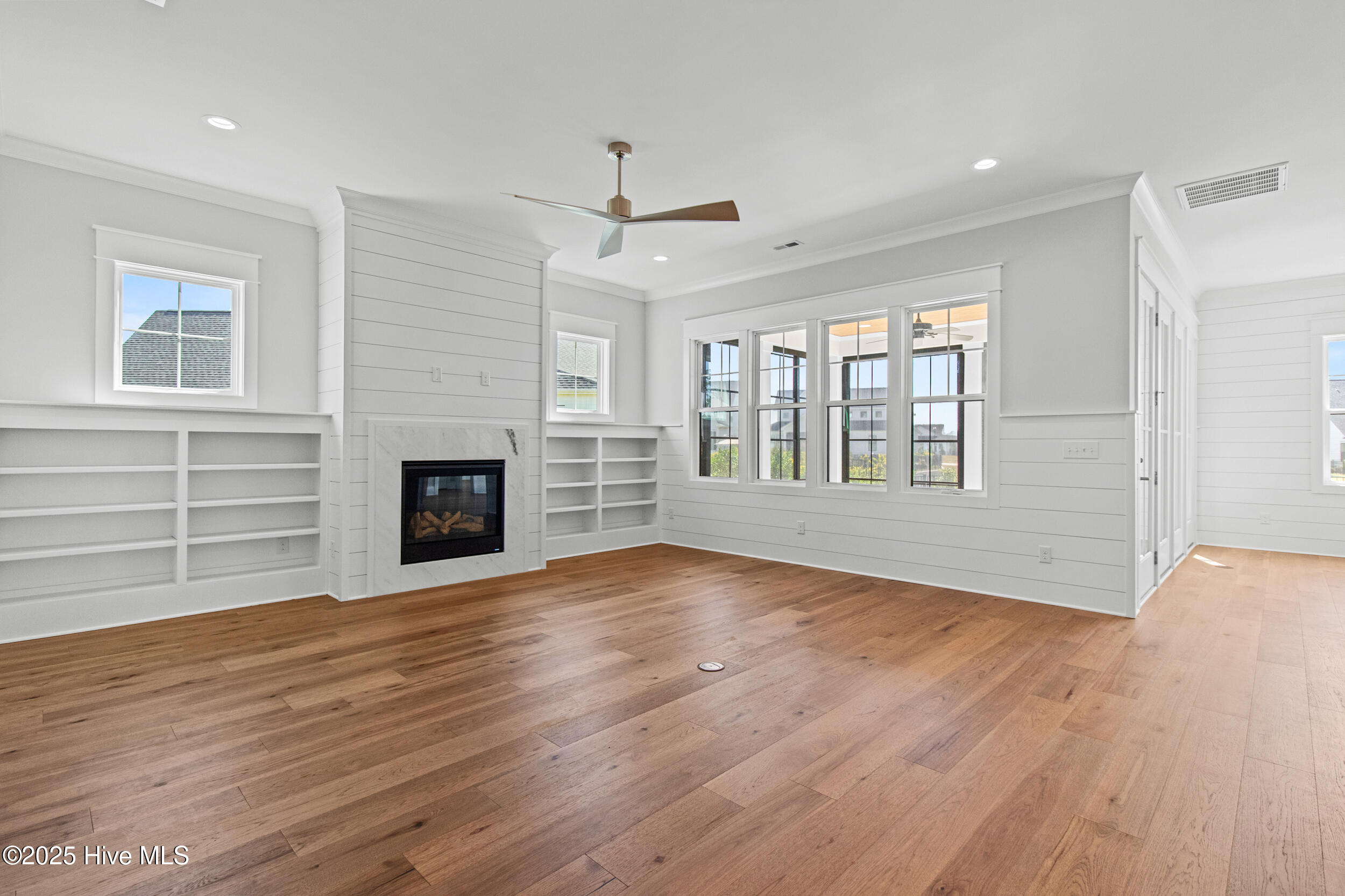 Living room with natural gas fire place and built-ins