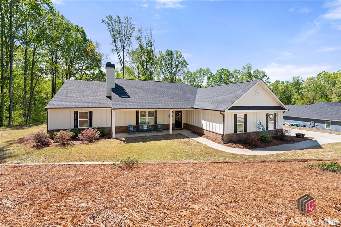TOSS the to-do list and MOVE right into this neat-as-a-pin RANCH in the sought-after Oconee Pointe! This home is only two years young and boasts many features sure to captivate any prospective homeowner! Upon entering, you will immediately notice the OPEN and spacious living areas that are the perfect setting for ENTERTAINING or spending time with those you love. The eat-in kitchen boasts classic shaker cabinetry and granite countertops and a large island where you can ENJOY a cup of coffee or the company of one another. Vaulted ceilings, recessed lighting, and AMPLE DOSES of natural light keep the space BRIGHT and AIRY. The living area features a COZY wood-burning fireplace with built-ins on each side. The primary bedroom is a true oasis, complete with a HUGE walk-in closet and an en-suite bathroom that features a double vanity, a luxurious soaking tub perfect for UNWINDING after a long day, and a separate shower. The home offers a split bedroom floor plan with the Primary suite located on one side of the home and two spacious bedrooms and a second bathroom on the other side, adding additional privacy. Outdoors you'll find space to RELAX on the back deck overlooking a peaceful and PRIVATE wooded backyard or IMMERSE yourself in a good book on the rocking chair front porch. Residents of this community RELISH the quiet and serene setting, yet also appreciate being convenient to everything. Don't miss your chance to make this stunning property your own and start creating memories that will last a lifetime.