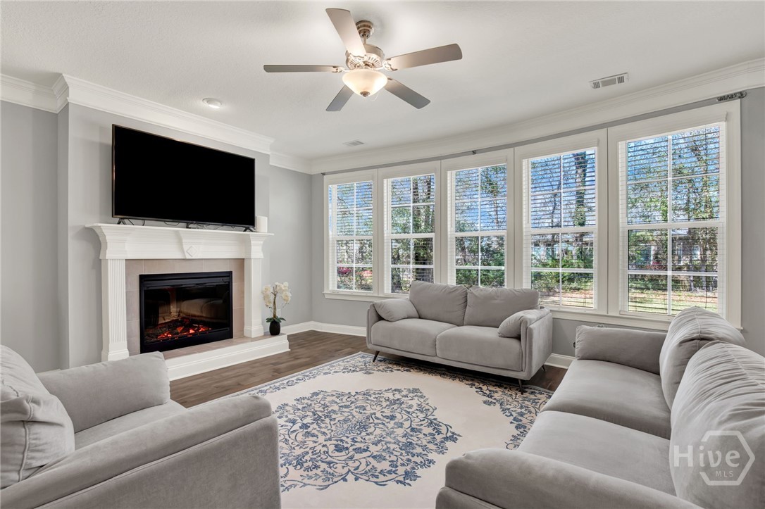 Family Room with Fireplace and Curved Wall of Windows