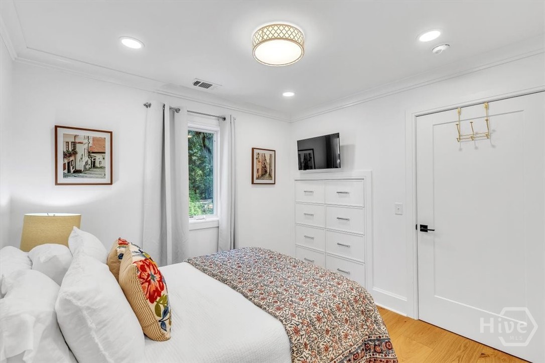 Bedroom in the carriage house features large closet and custom drawer built-ins.