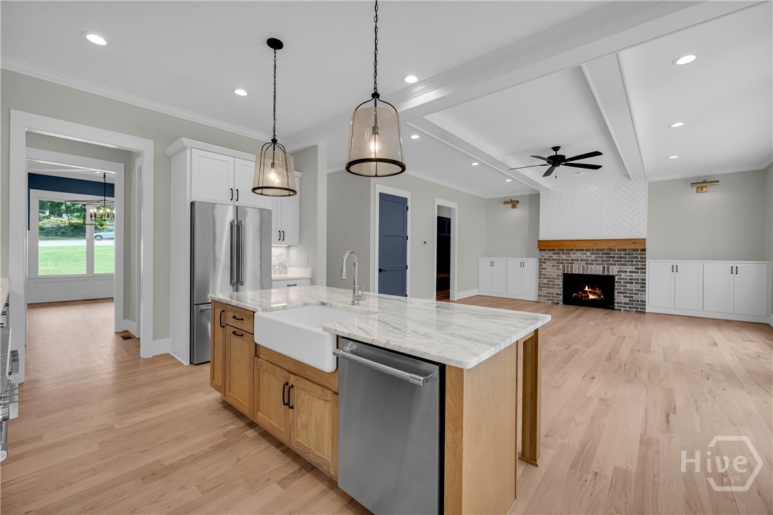 Stunning chef’s kitchen featuring marble and quartz countertops, a complete Thermador stainless steel appliance package, 5-burner natural gas cooktop, dedicated coffee station, and an impressive butler’s pantry for added storage and entertaining convenience