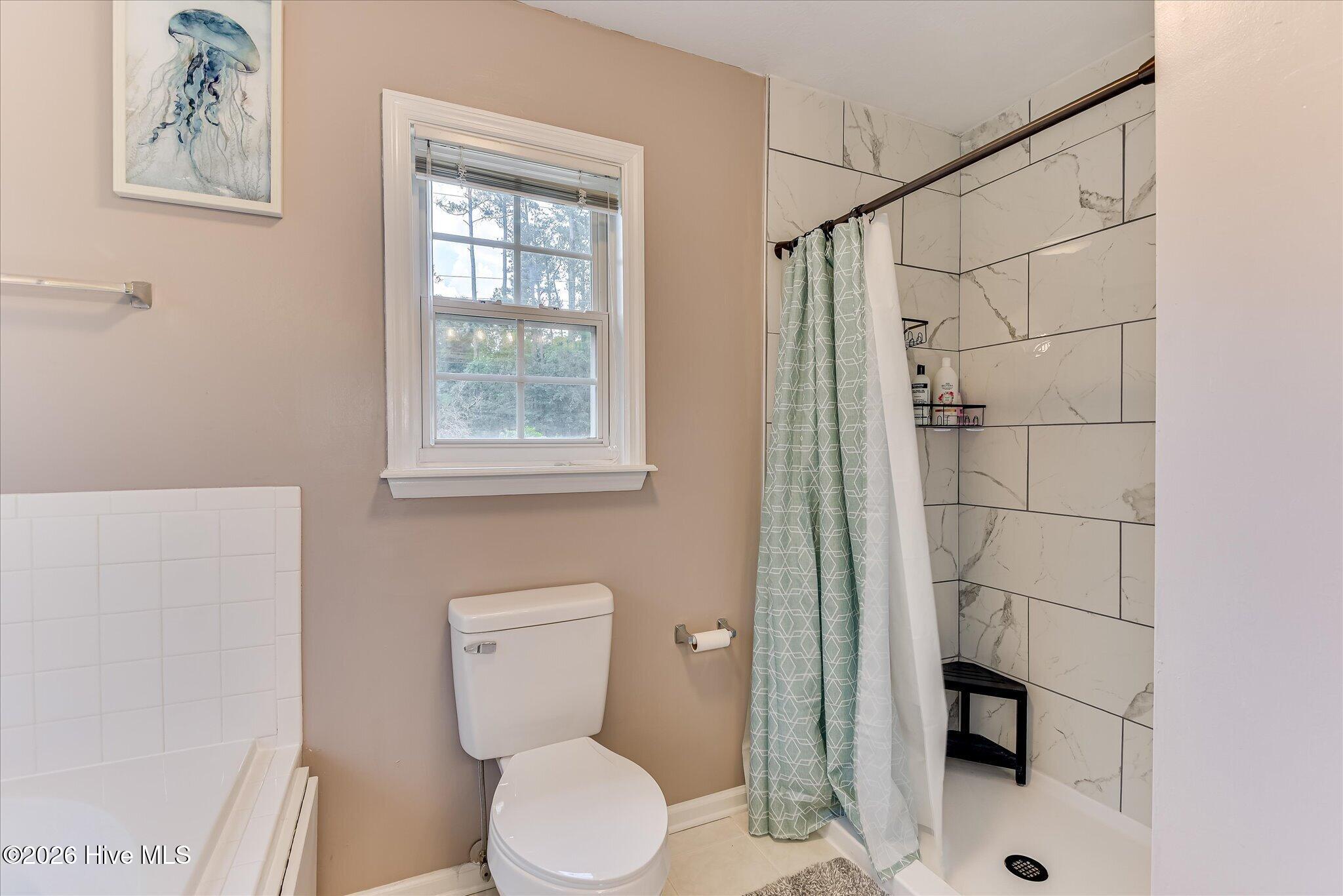 Primary Bath also has newly renovated gorgeous tiled shower.