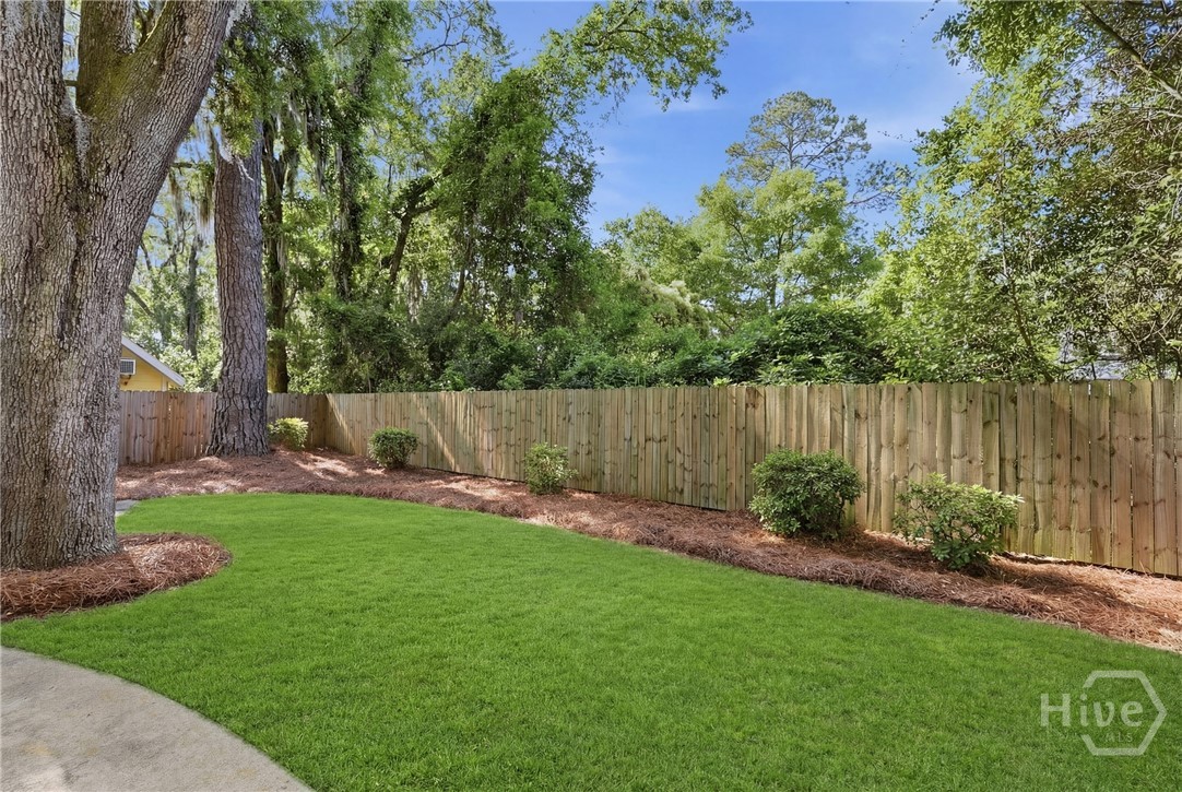 Privacy fenced backyard. Grass digitally enhanced for marketing