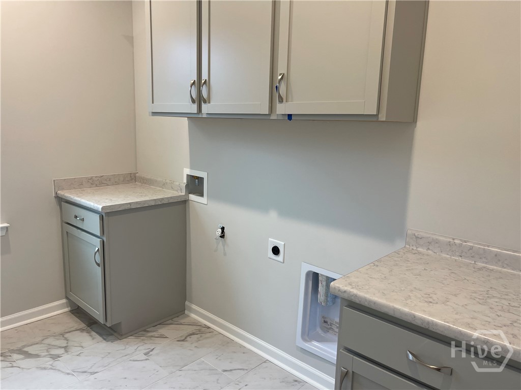 Laundry Room With Upper and Lower Cabinets
