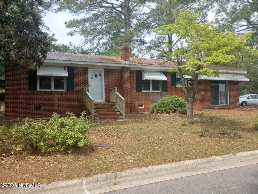 Three bedroom, 1.5 bath home with two paved driveways and a fenced yard.