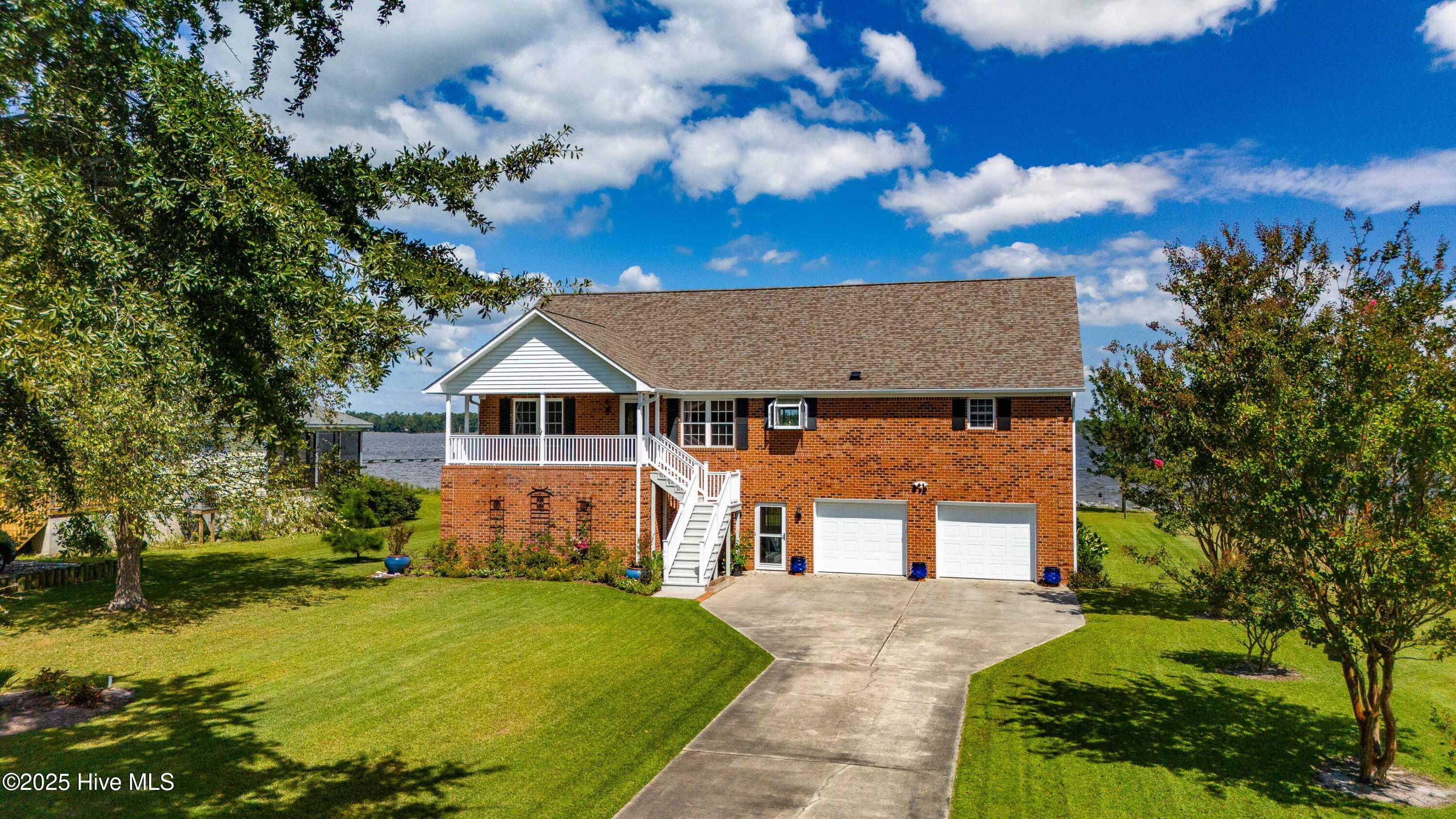 Set along the Bay River, this 3-bedroom, 3.5-bath waterfront home enjoys wide-open water views, steady coastal breezes, and easy access to the Neuse River and Pamlico Sound. With true river frontage, the setting offers a refreshing sense of space and sky—peaceful and expansive, yet just minutes from the village of Oriental. Designed for relaxed coastal living, the home's light-filled interiors are oriented toward the water, creating an easy flow between indoors and out. The kitchen is both functional and welcoming, featuring a hood and GE built-in microwave/convection oven, while a Monessen LP cast-iron stove adds warmth and character on cooler days. Recent improvements—including a new Daikin HVAC system on the ground level, a Rheem hybrid electric water heater, and a generator-ready electrical panel—bring added comfort and peace of mind. Outdoor living is a defining feature, with a generous deck and screened porch offering the perfect place to enjoy sunrise light, wind-driven water movement, and long, unhurried river days. The roof is approximately seven years old, storage is plentiful throughout, and established perennial gardens add color and texture to the landscape. An additional lot across the road provides space for an outbuilding, workshop, or expanded gardens. Located in Merritt, this property offers a rare opportunity to enjoy true Bay River frontage at an increasingly hard-to-find value—well suited as a primary residence, second home, or simple boating retreat.