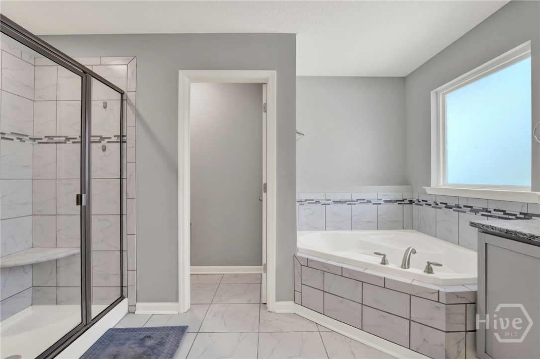 Primary Ensuite with Corner Soaking Tub and Separate Shower