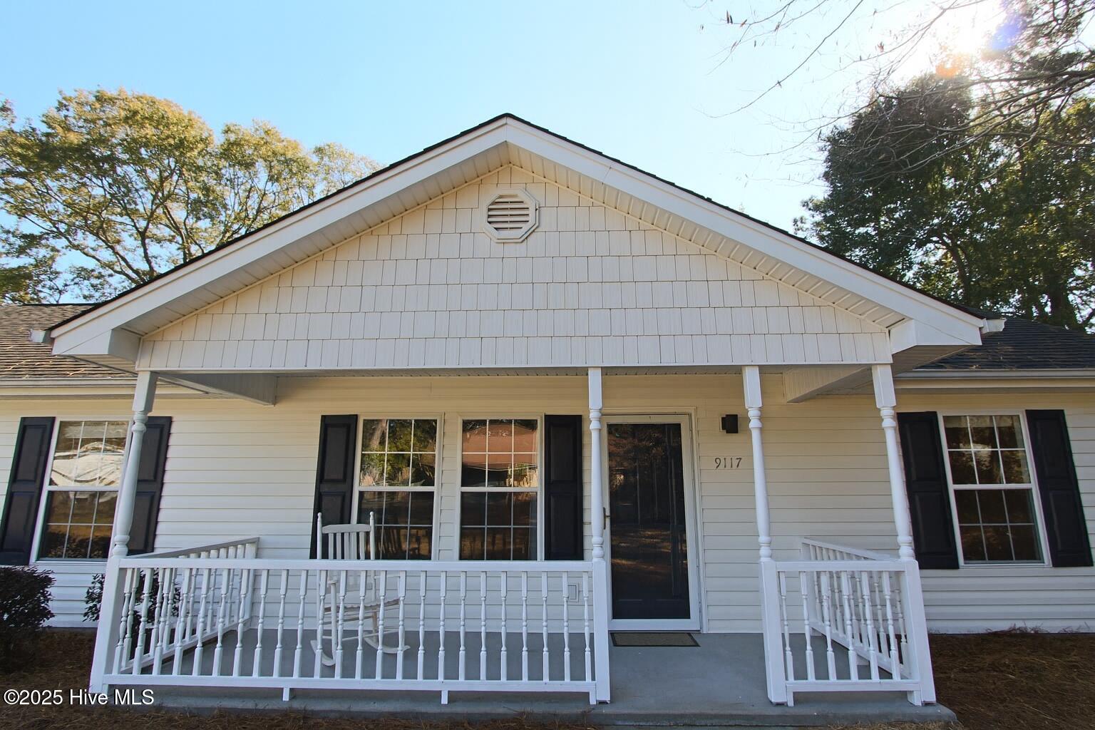 9117 Landing Drive SW, Calabash, NC 28467 – photo 11: Suburban Home Porch in Daylight
