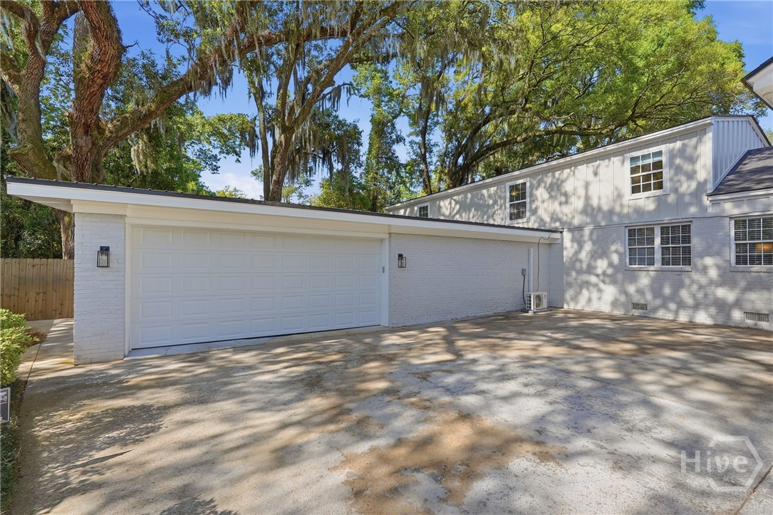 2-car garage with parking pad for 2 additional vehicles and long driveway for more vehicles