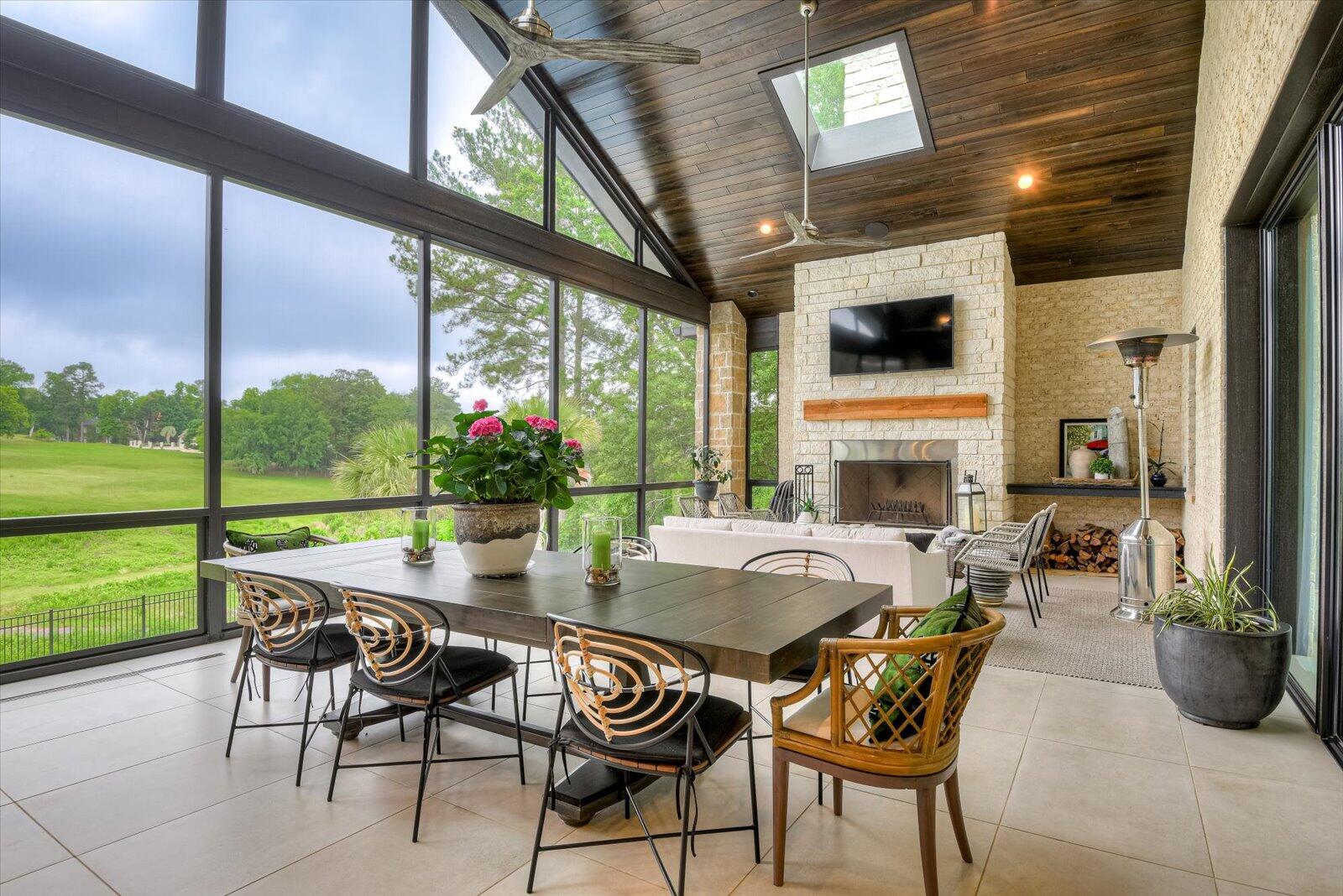 Upper Porch- Screen/glass enclosure; with large ceramic tile flooring. Wood burning stone fireplace. Tung & groove, stained wood ceiling with skylights and ceiling fans.
