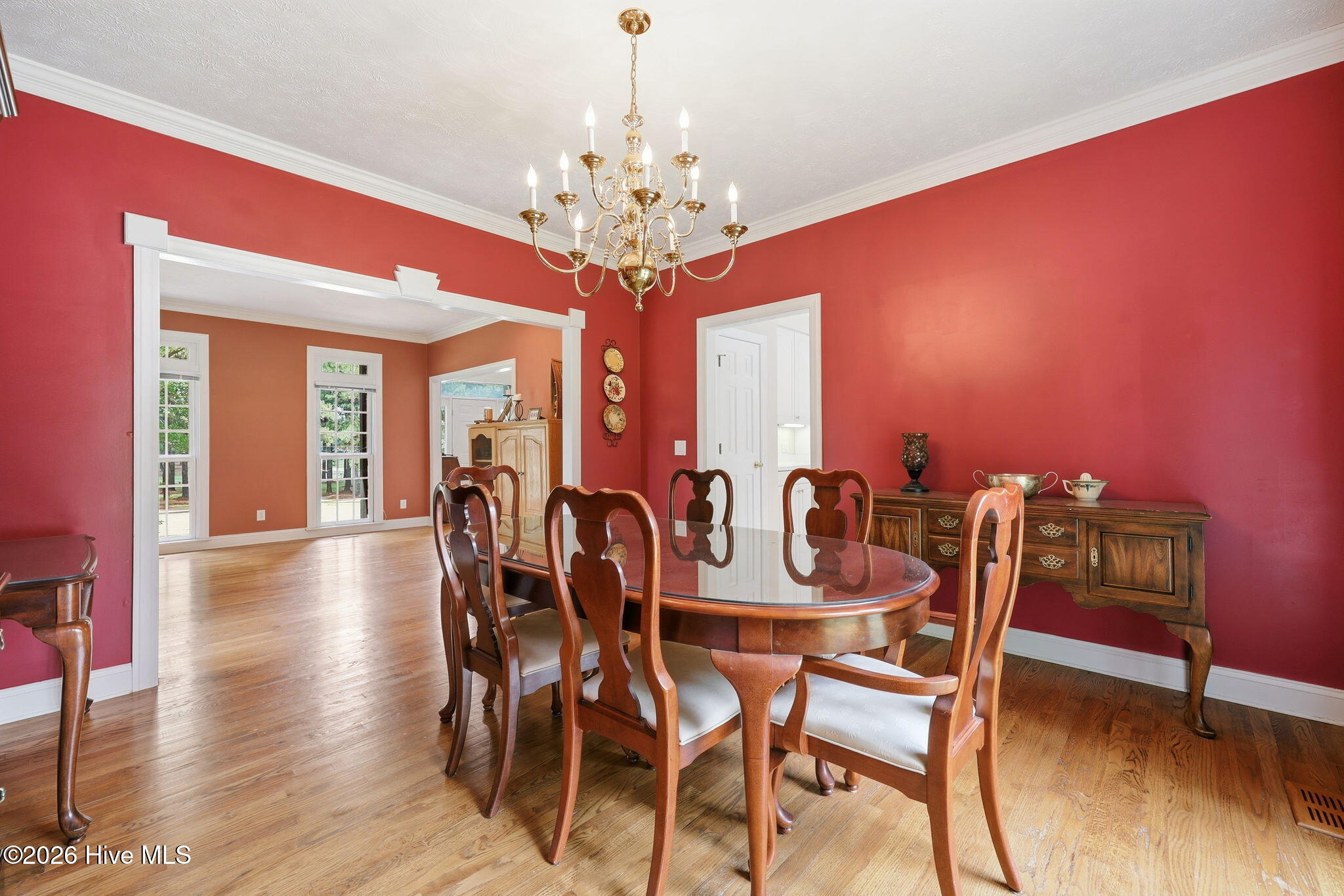 transition to the formal dining with detailed trim work and all wood floors throughout for flow