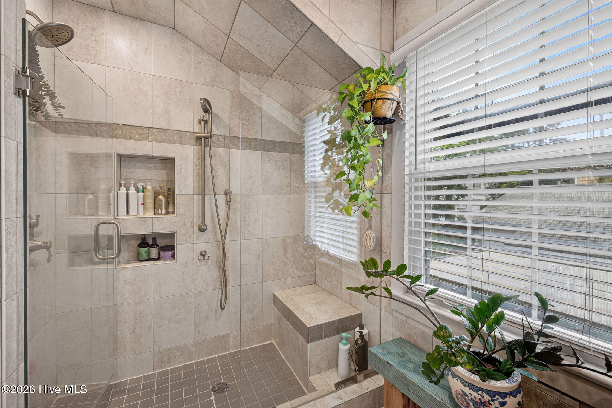 Walk-in tiled shower with glass surround
