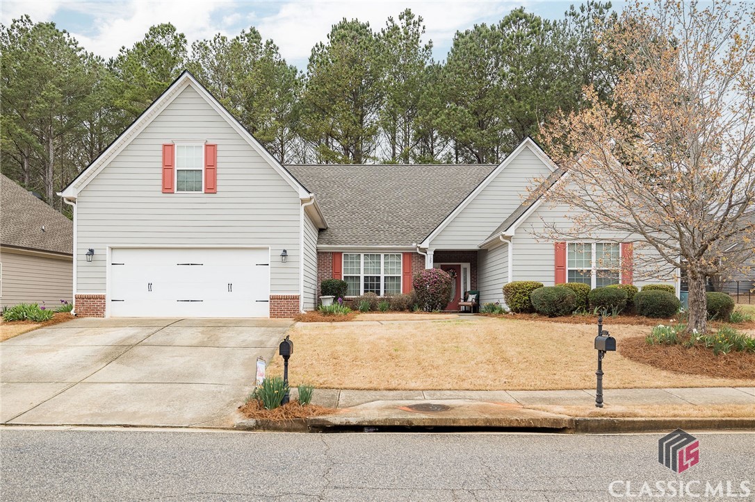 Welcome to 129 Kittle Lane in desirable Lake Meeler neighborhood located on the west side of Athens. This home offers an open floor plan which combines a welcoming foyer, a dining room with wainscoting, a spacious den with a  fireplace and vaulted ceilings, and a beautiful kitchen with a breakfast room.  The spacious kitchen features granite counter tops, tile back splash, and a double oven. Just off the kitchen, there is an office with built ins, and beyond that, a large laundry room.  On the main level there are 3 bedrooms and 2.5 baths with a split bedroom arrangement. The spacious owners' suite has vaulted ceilings, a large walk-in closet, and a lovely owners bathroom with double vanities, a shower, and a soaking tub. The upstairs features a very large bedroom with a nice closet and a full bath. The backyard offers a private and peaceful setting with a patio and fenced yard. It also has a two car garage.The home features brand new carpet, new interior paint throughout, a new HVAC, a new roof, and new stove top and dishwasher. It has been lovingly maintained and is move in ready for its next owners.