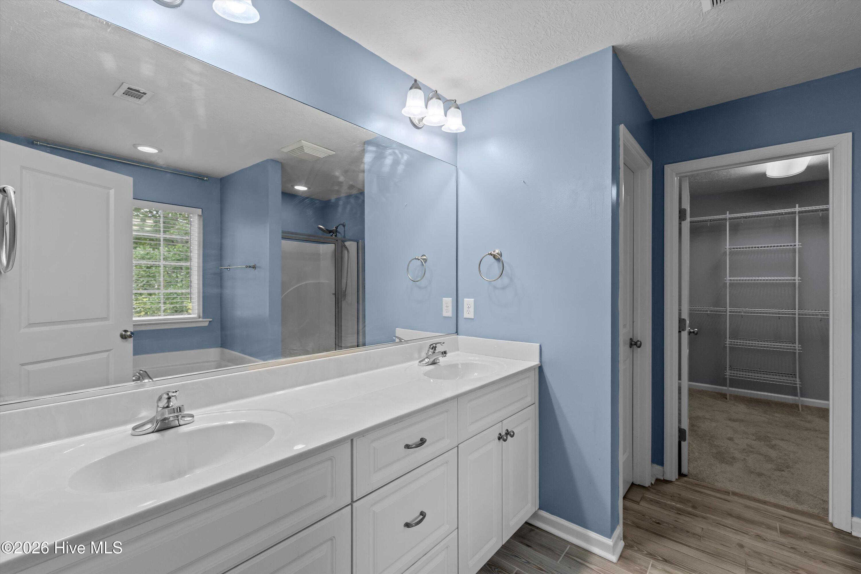 Primary Bath with soaking tub walk-in shower and access to large closet