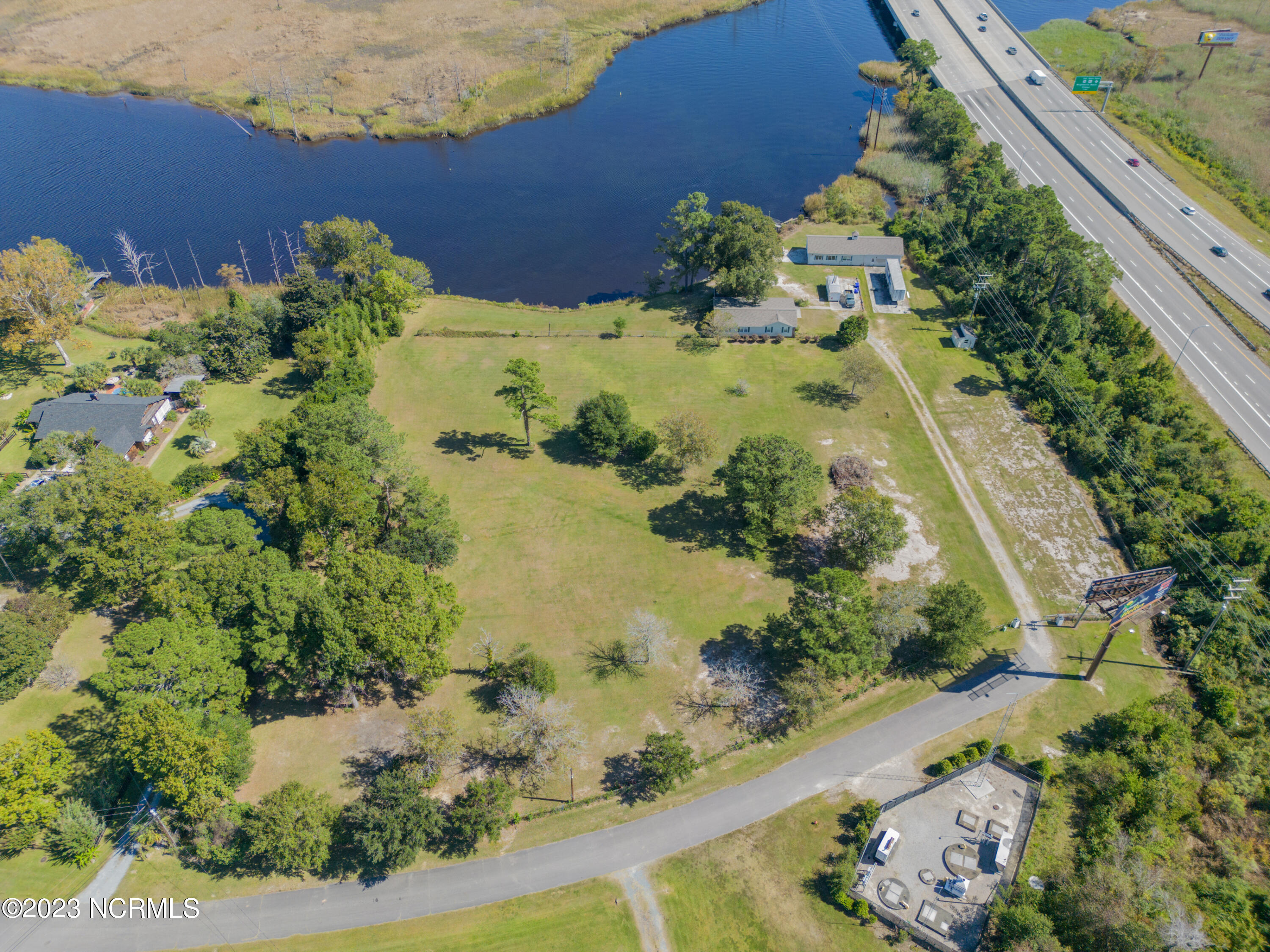 Wonderful opportunity to own and develop this beautiful property with 530 feet on the Brunswick River.  There is a total of approximately 11.3 acres of land with 4.6 +/- acres that are developable.  Will sell as a single family lot development or will sell subject to rezoning for townhomes or attached housing. This property includes 4 parcels- 038BD034, 038BD033, 038D032 and 038BC019.  City water and sewer is available.  Structures on property are damaged and are considered to  have no value.