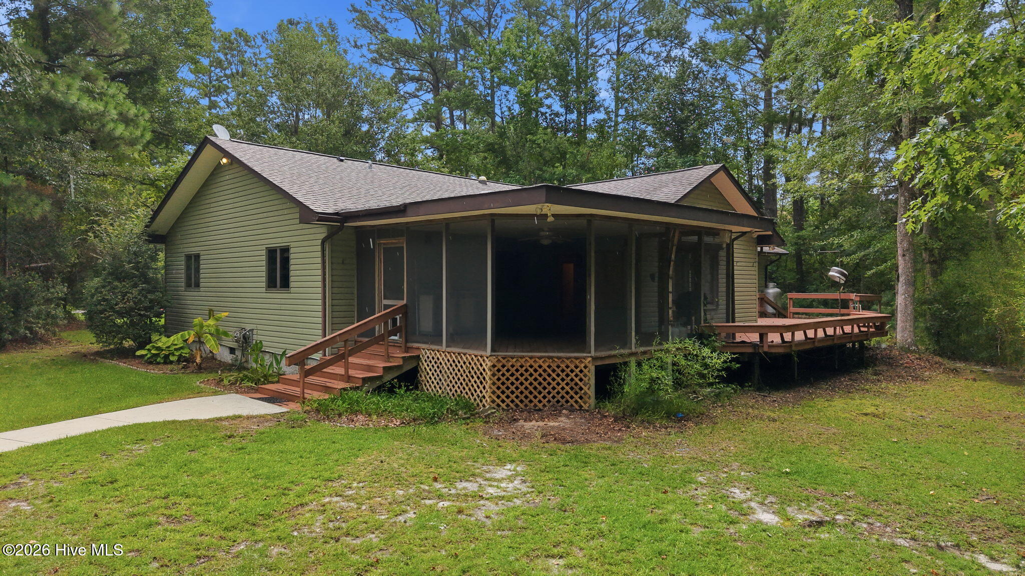A waterfront residential opportunity, within walking distance of Oriental! Here's your chance to own a large, 3-bedroom home which is beautifully and privately situated on over 138' of bulkheaded, creek/canal off Green's Creek. The home has been thoughtfully designed to accommodate the needs of a couple or family with equivalent ease... From the foyer, the open design of the vaulted living and dining room (wood floors) ushers you into a lovely space which features a corner fireplace, a bank of windows overlooking the large rear deck and easy access to the chef's kitchen! The kitchen has lots of light, granite counters and abundant cabinetry. In fact, the entire home has lots of built-in wood cabinetry, display shelving, counters, bookshelves and more! It is a feature unique to this residence and an attractive design element. The bedrooms are nicely separated by the public areas. A master wing overlooks the private back/side yards, has lots of closet space, an ensuite bath and private access to the large (10' x 24') deck! The guest wing features a big corner bedroom and a third bedroom that was converted to an office/den and could serve in many capacities for your unique needs. There's so much to like about the home, which awaits your updates and upfits. The outside living areas add a great deal of associated living...  There's a large welcoming covered front porch, as well as a huge, 17'10'' x 19'5'' screened porch adjoining the living room & deck w/lovely glimpses of the tranquil creek! The waterside yard area will entice you with a boat lift, bulkhead, protected waterfront, and views out the creek! An amazing feature awaits the craftsman, boater or hobbyist - a very large storage/garage workshop built practically on the water!! It's 23'+ x 29' interior allows a multitude of uses. It has a large garage door, a wood stove & an extensive workbench w/shelving! A covered storage area does double duty as a waterfront sitting area! So much to see and such a great price!