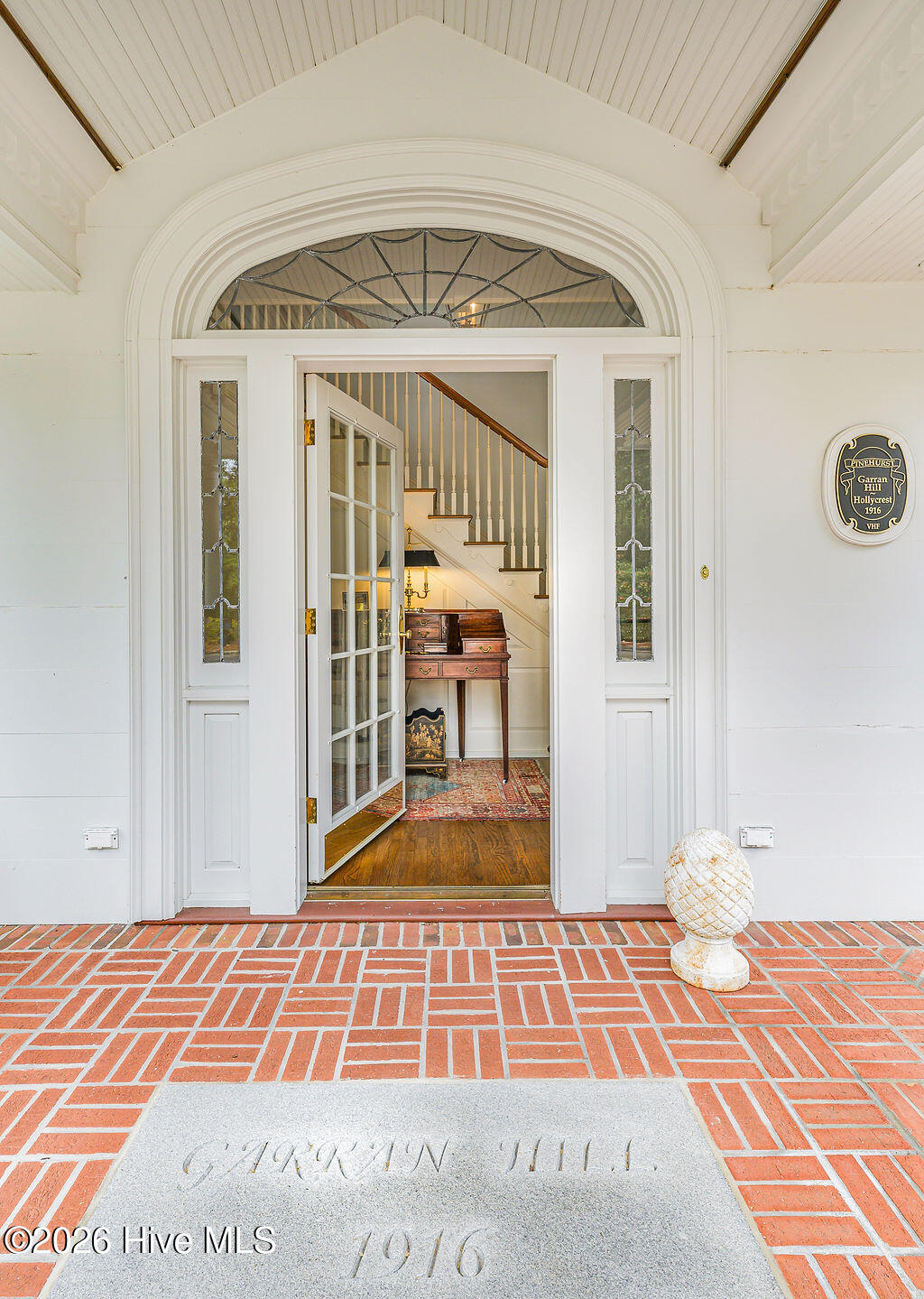 Herringbone brick floor, original leaded glass sidelights, arched fanlights