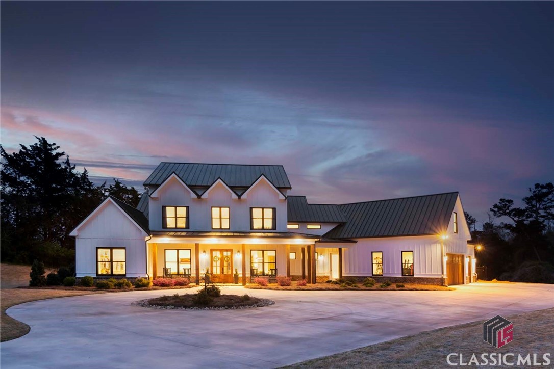 Welcome to 1876 Archer Grove School Road, a custom-built Craftsman Contemporary masterpiece sited on 11.11 acres in Jackson County yet just ten minutes to Normaltown and Downtown Athens. Priced at recent appraised value! The gently curved 750ft paved driveway grants an abundance of privacy from the road as does the home’s position on the lot. Upon entering the home through French Doors, the spaciousness and attention to detail is immediately clear. From White Oak hardwood flooring, ten-foot ceilings, and nine inch baseboards to the fully customized kitchen complete with Wolf oven, there are so many fantastic features to appreciate. Flanking either side of the wide entry foyer is a home office and a formal dining room with coffered ceiling. A walk-through wet bar with ample storage connects the kitchen and dining room. In addition to the wet bar, a Butler’s Pantry is adjacent to the kitchen. Custom cabinetry with soft-close drawers & doors, Wolf convection oven with griddle, integrated SubZero refrigerator, Bosch triple-drawer dishwasher, Brunello Quartz countertops, large island, and breakfast nook complete this chef’s dream of a kitchen. A spacious mudroom with built-ins leads to a spacious laundry room as well as the garage with three spaces and solid cedar garage doors. The Greatroom features a masonry fireplace, 20ft ceilings, and multiple large windows overlooking the gunite, saltwater pool. A covered porch complete with tongue-in-groove cedar ceilings and a fireplace greet you as you exit the home to enter the fenced backyard. The rectangular saltwater pool has a tanning ledge perfect for keeping cool while sunbathing in the summer. Prepare to be impressed by the massive primary suite complete with Smart Shades, plantation shutters, an ensuite bathroom with enormous walk-in shower and soaking tub. You will never run out of counter space with these his & hers vanities. Another luxury you’ll never run out of is closet space – the primary suite closet offers a custom closet system and center island/ built-in dresser.Industrial railings guide you upstairs where four additional bedrooms and a spacious bonus room are located. Three of the four bedrooms have their own private bathrooms and all have large closets. The bonus room has a private stairway directly into the garage.There are far too many wonderful features and customizations to list in this description! Reach out to your Realtor for a complete list of upgrades and schedule your private tour!