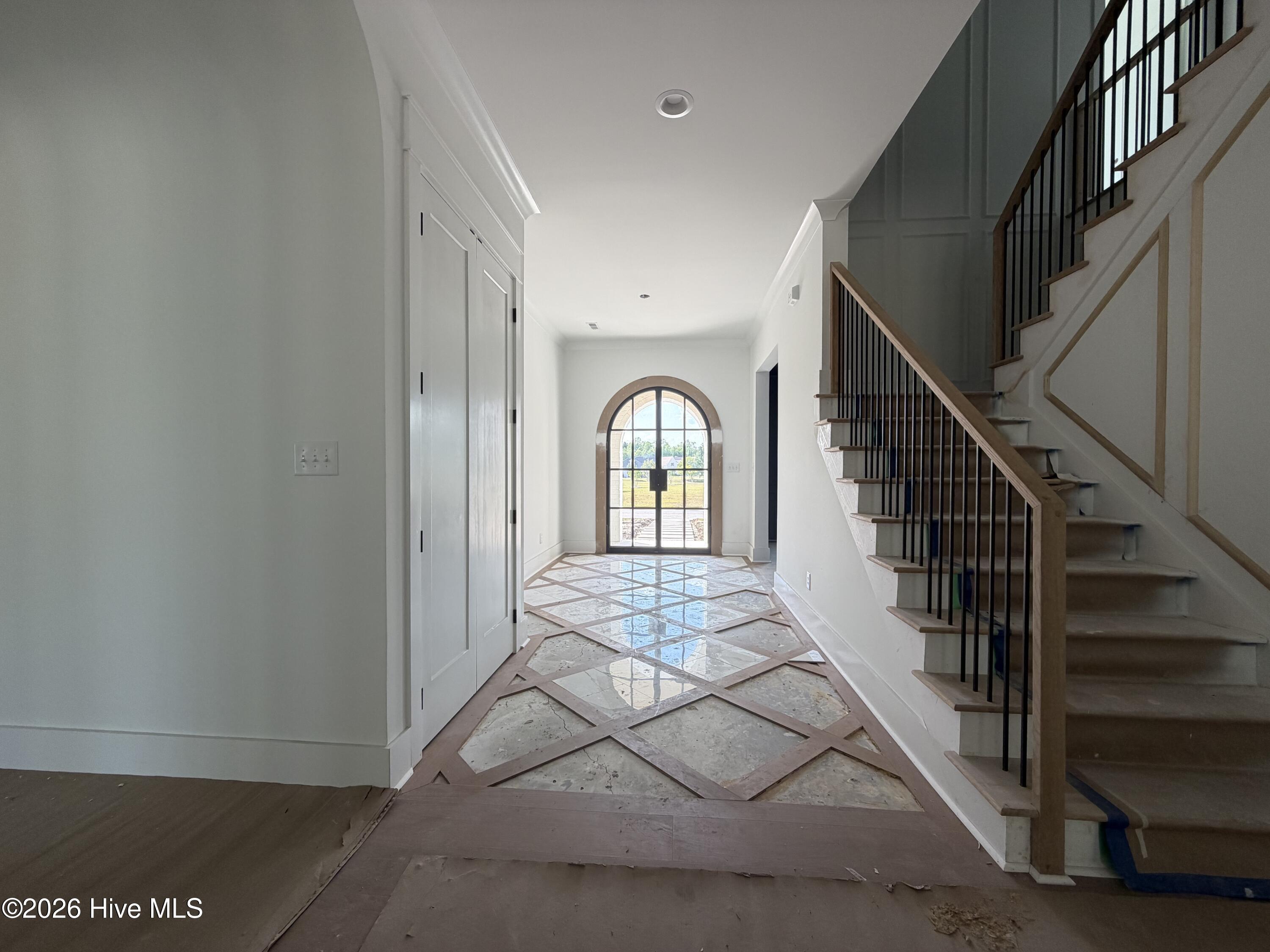 look at this ! wood and marble inlay foyer flooded with natural light