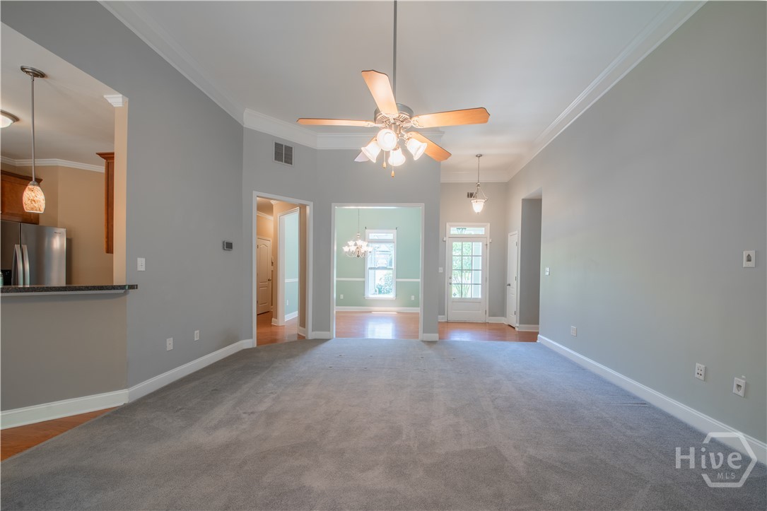 Living Room looking to front door and Dining Room