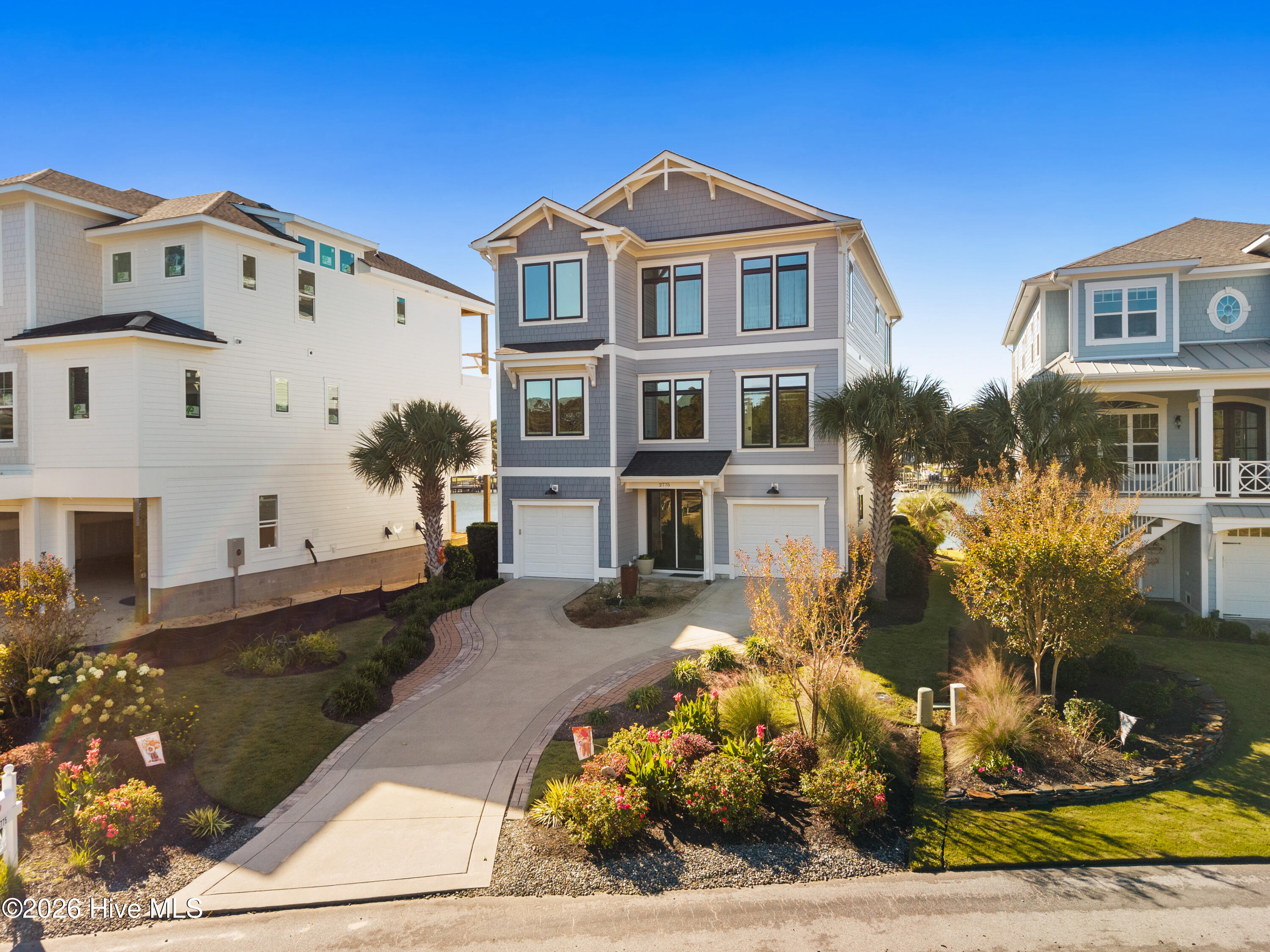 Crepe myrtles, knock-out roses, oak-leaf hydrangeas and grasses provide a palate of color in the front of the home