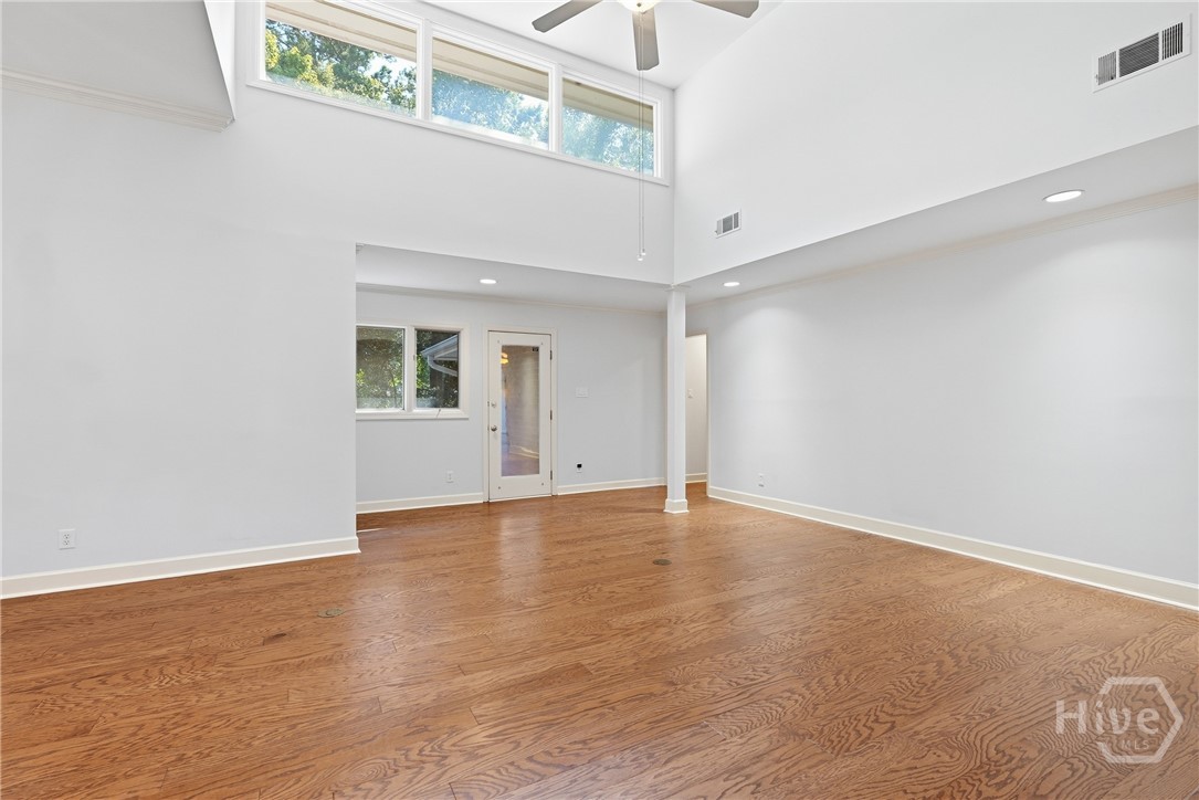 The living room has direct access to the side yard, where you will find mature, fruit bearing orange trees!