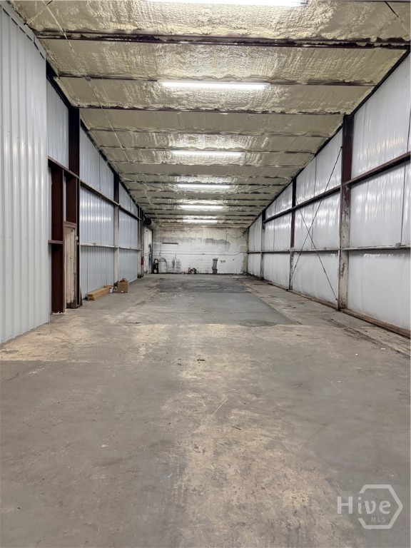 Second side of building with one garage bay at store front.