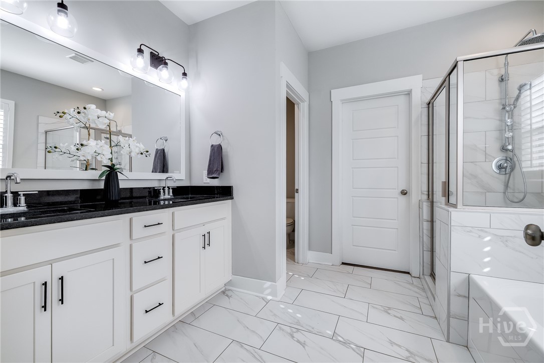 Primary Bathroom - Duel Vanities, water closet, Large walk in custom closet.