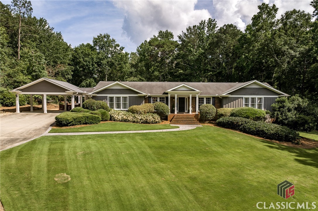 Nestled within the prestigious Crystal Hills community, this exquisite residence sits on 3.47 acres of beautifully wooded, private land—an idyllic setting for refined living. Meticulously updated and expanded, this traditional ranch-style home exudes timeless elegance with a touch of modern luxury.Upon entering, you're welcomed by an inviting foyer adorned with architectural encasements, flowing seamlessly into a handsome home office, a spacious formal dining room, and a charming sitting room anchored by a gas log fireplace. Rich hardwood floors extend throughout the main level, lending warmth and cohesion to the living spaces.The heart of the home is the fully reimagined gourmet kitchen—renovated to the studs and designed for both function and beauty. Featuring soaring vaulted ceilings, stunning Quartzite countertops, double wall ovens, a 6-burner gas range, and an abundance of custom cabinetry, the kitchen also includes a walk-in pantry, a wet bar with wine cooler and sink, and a thoughtful layout that invites gathering and entertaining.An expansive great room addition enhances the home’s livability, with vaulted ceilings and walls of windows that flood the space with natural light and offer picturesque views of the rear lawn and outdoor entertaining terrace.Tucked just off the kitchen is a newly constructed laundry room, complete with a utility sink and folding station, along with a stylish powder room for guests.The main level features three generously sized bedrooms, each with en suite baths and walk-in closets. The private owner’s suite, set in the quiet rear wing of the home, boasts a tranquil bay window, a luxurious spa bath with soaking tub, large tiled shower with built-in bench, and beautifully crafted custom cabinetry (renovated in 2023). A spacious walk-in closet, large enough to include a built-in desk, completes the suite.The open stairwell leads to a light-filled terrace level with terracotta tile floors in the main living area, a large guest bedroom with engineered hardwood flooring, a full hall bath, and French doors that open to the side lawn. Multiple full-sized windows ensure every space is bright and welcoming. Two additional rooms provide generous storage or flexible use.The crown jewel of this property is the custom-designed open-air entertaining lodge, completed in 2021. With a soaring vaulted ceiling, masonry wood-burning fireplace, and elegant stone flooring, this outdoor haven is the perfect setting for unforgettable gatherings with family and friends.This is a rare opportunity to own a truly distinguished home that balances privacy, luxury, and the natural beauty of its surroundings—all within one of the area’s most sought-after communities.