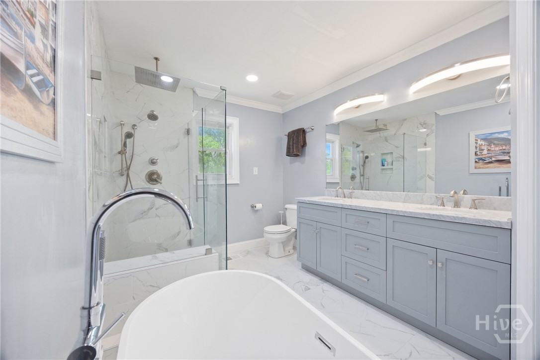 Beautifully renovated bathroom featuring a soaking