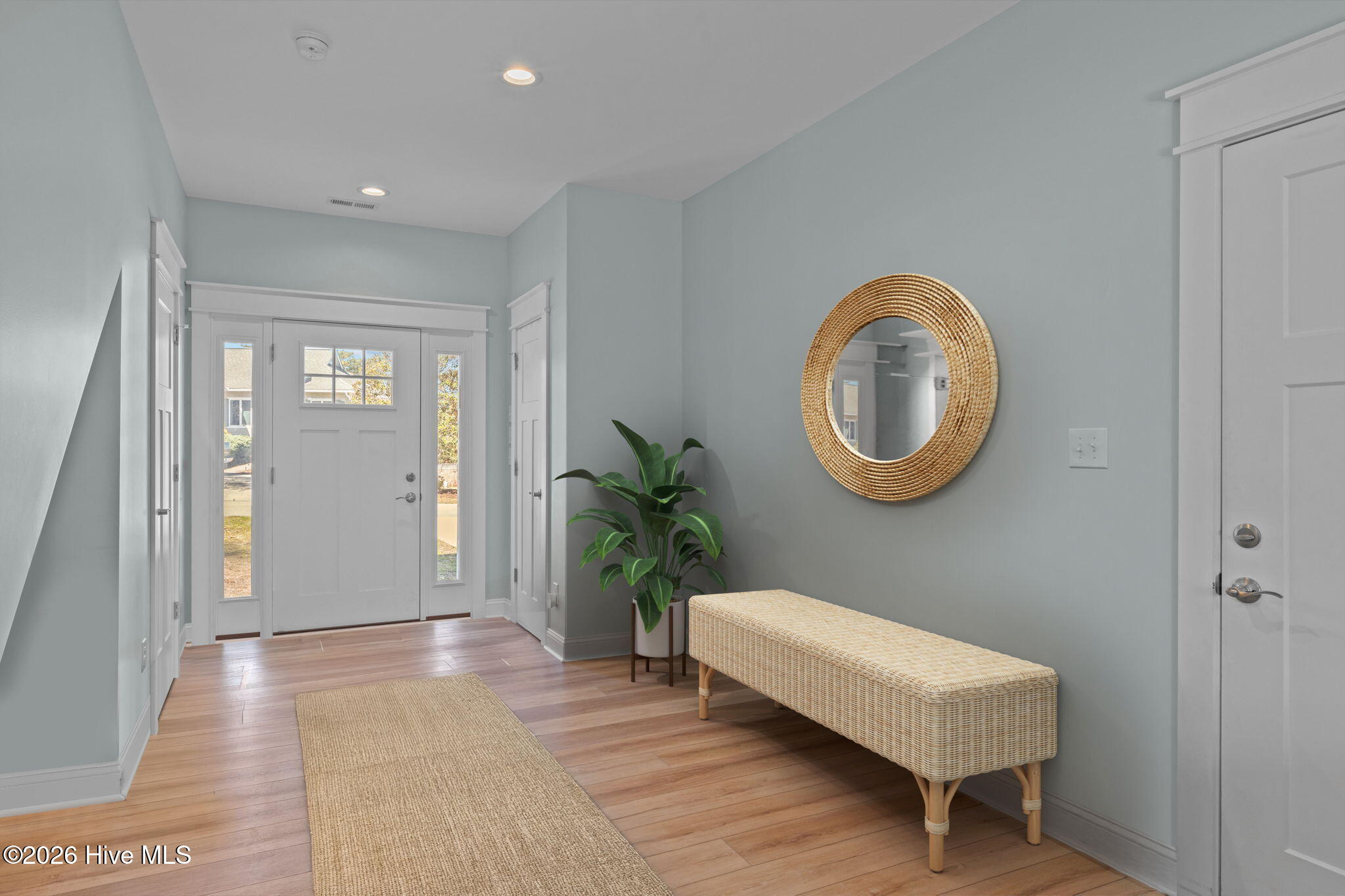 1st level ~Stagged Entry with half bath- access to double garages and flex space