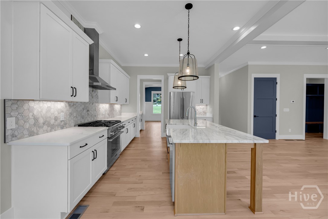 Stunning chef’s kitchen featuring marble and quartz countertops, a complete Thermador stainless steel appliance package, 5-burner natural gas cooktop, dedicated coffee station, and an impressive butler’s pantry for added storage and entertaining convenience