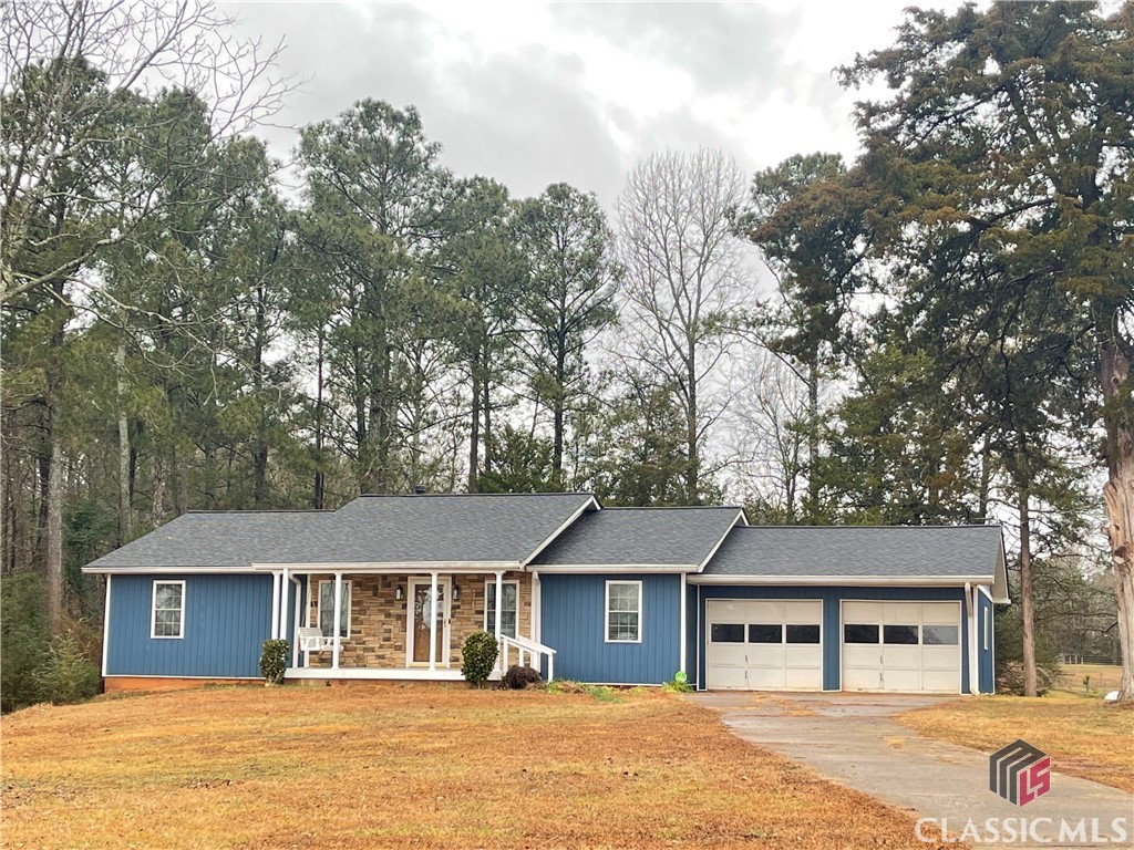Discover this charming 3-bedroom, 2-bathroom ranch nestled on a spacious one-acre lot in Lexington. As you approach the home, the expansive front and left yards create a picturesque setting. Step inside through the covered front porch into the inviting great room, seamlessly connected to a dining "L" for versatile living.The house boasts a well-designed layout, featuring a two-car garage and a covered deck for outdoor enjoyment. The kitchen, complete with a convenient laundry and storage room, is both practical and spacious. Moving down the hallway, you'll find a primary suite with ensuite bathroom, two additional bedrooms and one bathroom. The full unfinished basement offers endless possibilities with its open space, laundry hook-up, and a door leading to the outside. Additionally, a roll-up door is provided for easy access. This property combines functionality with a serene setting, creating a wonderful place to call home.