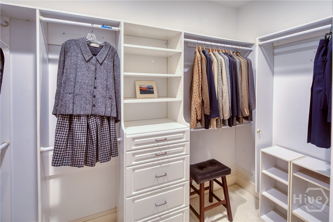 Walk in closet on hallway to bath
