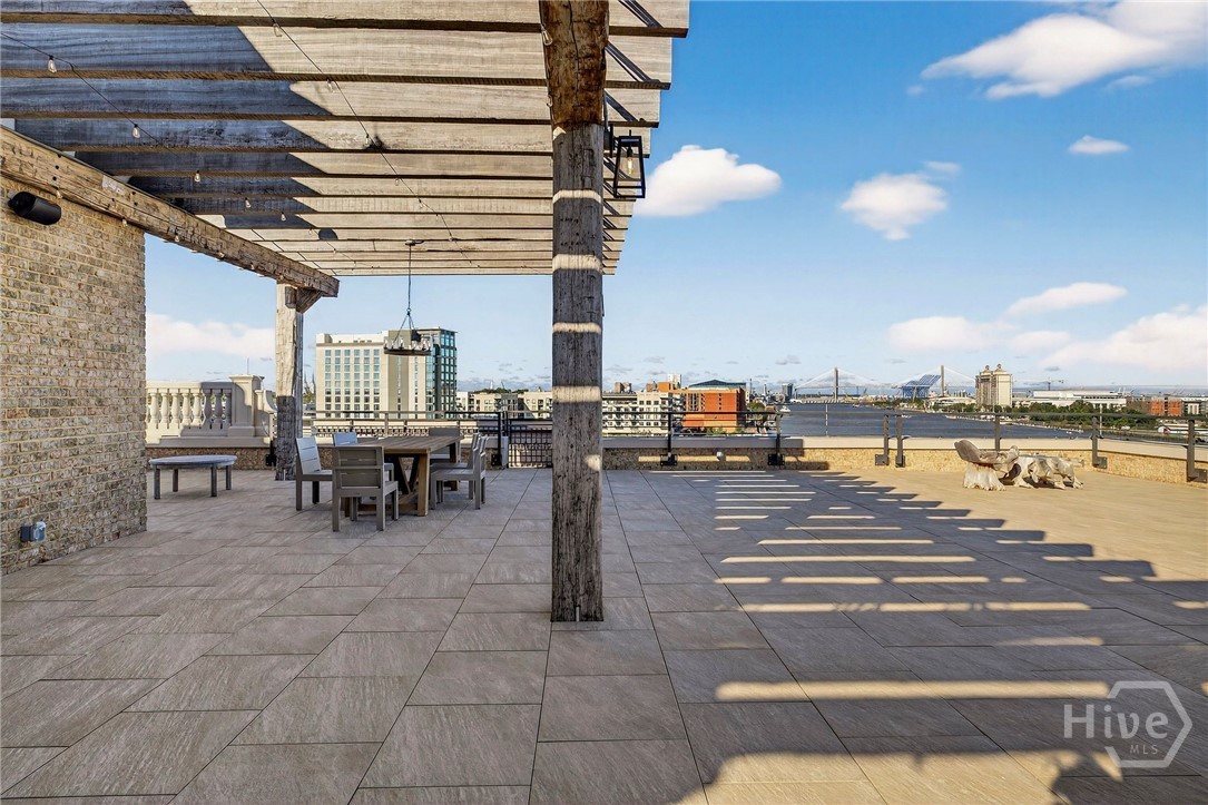 An expansive private rooftop terrace, exclusive only to the Penthouse, combines shaded dining and open lounge zones with sweeping skyline and river views. The pergola structure defines the space, while the fire pit and tiled flooring create a dynamic setting for entertaining. A rare outdoor experience with architectural???????????????????????????????????????? distinction.