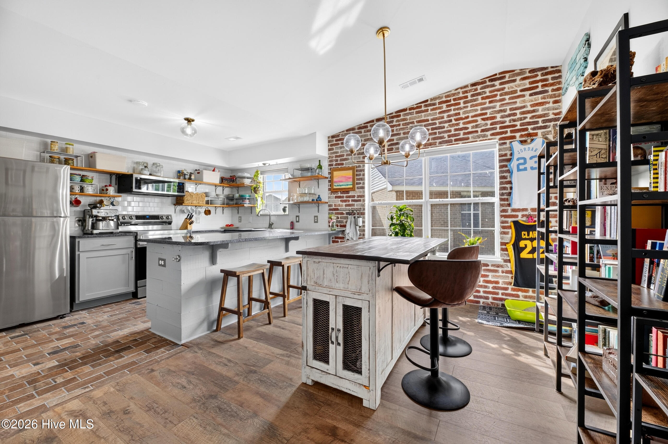 Brick on wall, fireplace and floor elevates the home feel