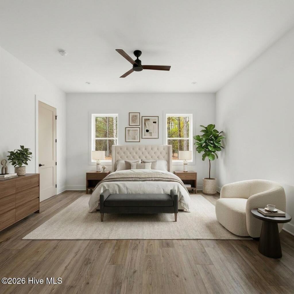 Primary bedroom with two walk-in closets and custom shelving