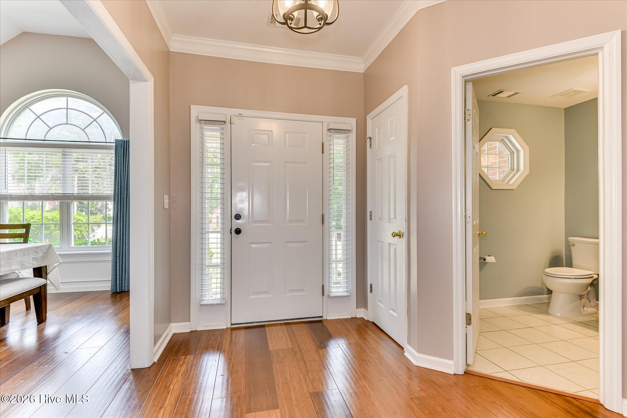 Welcoming Foyer with lovely wood floors