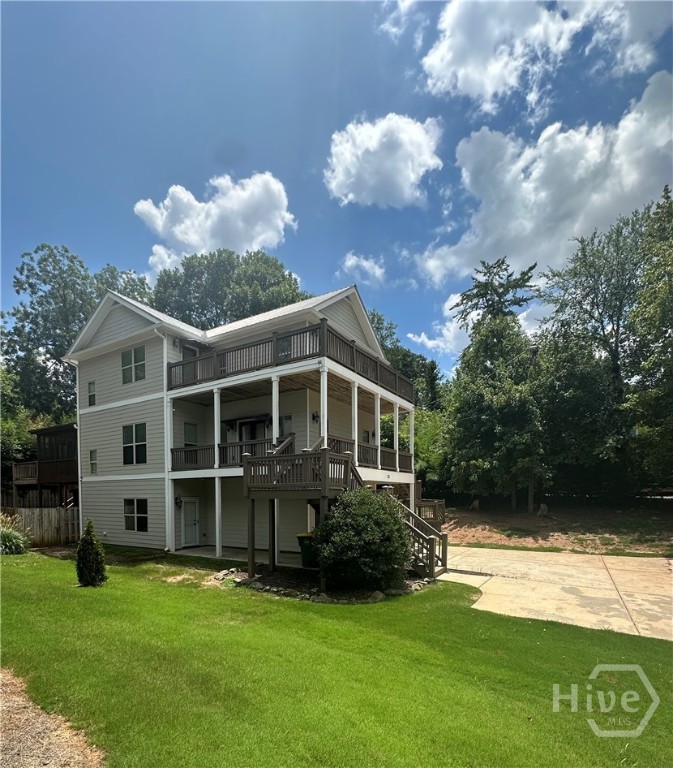 What a spectacular slice of Athens paradise. Situated in the heart of DAWG country and boasting unsurpassed convenience to Downtown Athens, the Classic Center, Dooley Field at Sanford Stadium and UGA—this showcase craftsman is a true CLASSIC! Upgraded with standout appointments and move-in ready condition, this “Charleston-styled” tri-level boasts a dynamic plan that definitely stands out. As you approach, the verdant, lush lawn accented by hard-scape draws you in. Greeted with double piazza decks, outdoor living options are definitely not limited. Welcomed by the main floor you’re immediately taken back by this homes conversation piece, the 3rd floor balcony overlooking the great room. The palatial ceilings adds immense charm, and allows natural light to engulf the space. Quite spacious, the great room is the perfect gathering spot, and boasts a fireplace as well offers the quintessential entertaining layout overlooking the kitchen. Well equipped and stacked with upgrades, the gourmet kitchen features it all—Custom cabinets accented by a tile backsplash, butcher block counters offer ample space for meal prep, even more space is provided with the granite-topped island, not 1 but 2 pantry options, and was recently upgraded with a completed stainless appliance package. To ensure ample seating for all, the kitchen offers an extended, raised breakfast bar and an oversized sunlit dining room that could easily seat 8+. The main floor is complete with a guest bedroom, perfectly appointed full bath, and the laundry room for added convenience. Ascend the stairs to find an additional all-inclusive bedroom suite with private full bath, as well as the owner’s suite. No stone left unturned, the primary is an extraordinary retreat enhanced with a double tray ceiling, spacious closet with shelving, ensuite bath and private access to the 3rd floor balcony with extended views of Downtown Athens. The primary lavatory continues to inspire with a dual-sink vanity, large tiled shower, and Whirlpool tub encouraging relaxation. Where’s the upper level balcony you may ask…through French doors this owner’s retreat gives way to 360’ catwalk balcony with stunning views. It’s truly a unique experience and would make the perfect library. Need even more room to expand? The lower level provides an additional bedroom and full bath with private exterior access. Although the wrap-around decks are glorious, you may prefer a more private setting, and the rear screened porch provides the perfect spot for year-round enjoyment. An open-air deck extends off the porch creating the perfect spot for grilling out. Adding to this total package is the fenced rear and side yard perfect for your fur babies, plus an additional storage building tucked away under the rear stairs. Providing an extra sense of security, both HVAC systems as well as the water heater were updated within the last year. Superior Convenience, Sought-after Location, and Upgraded Features combine to create the cool vibe that is N. Poplar Street!!
