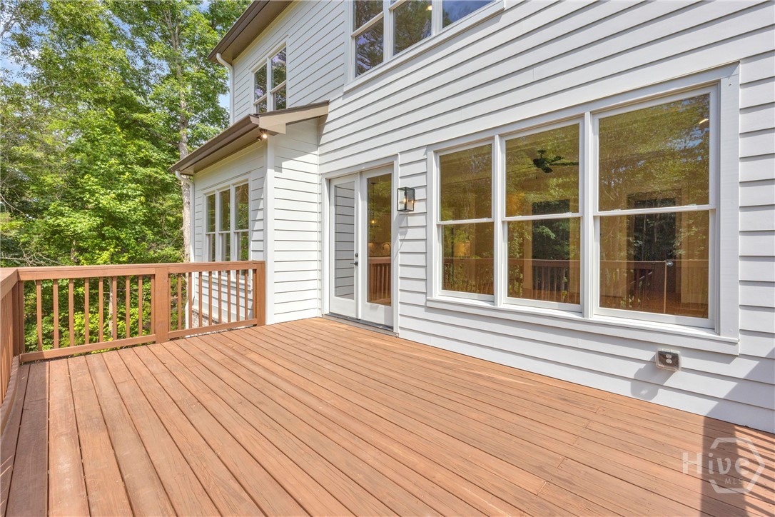 Spacious exterior deck with wood-finish flooring and matching wood railing