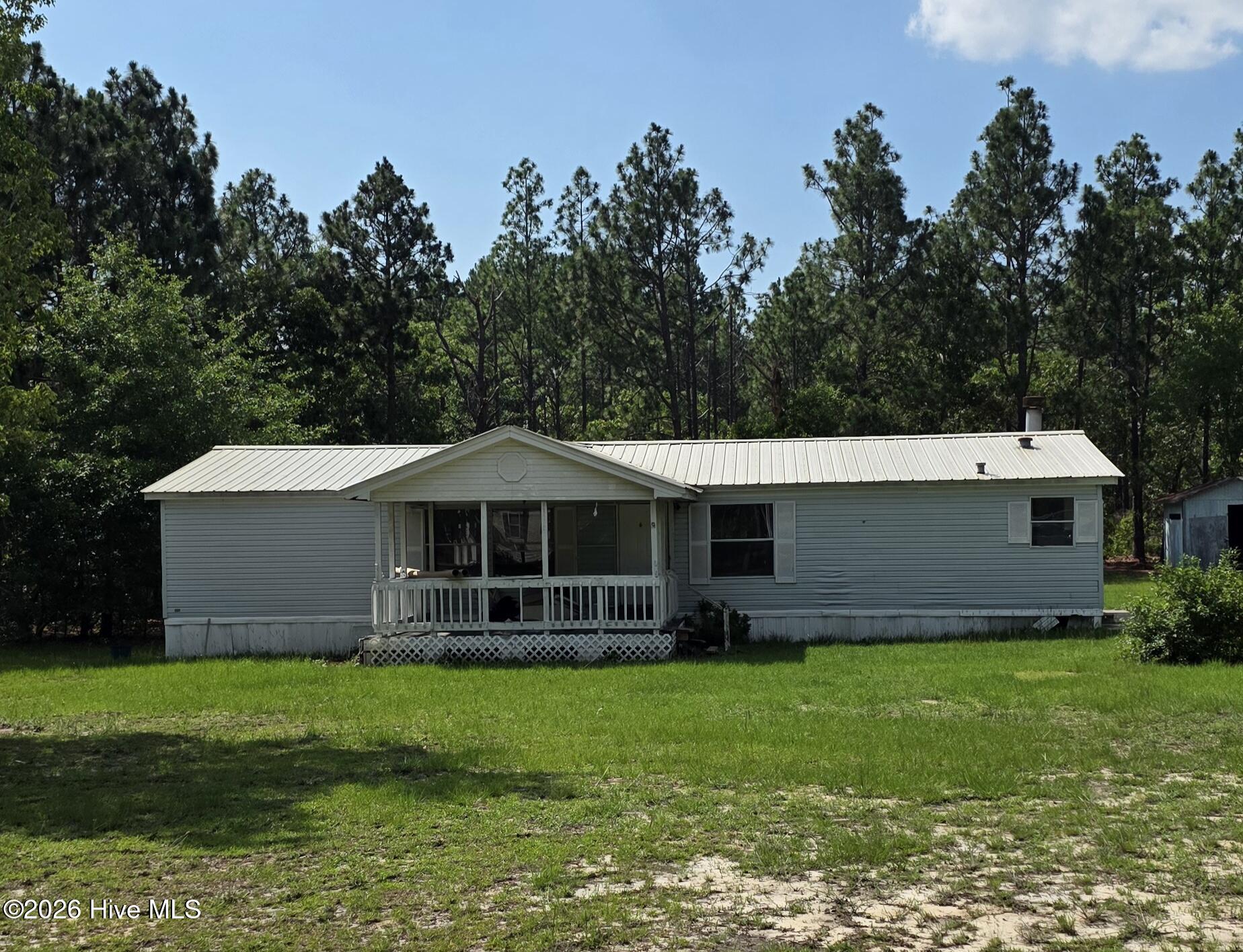 Spacious 3 bedroom 2 bath doublewide manufactured home with 2.28 acres of land outside the city limits!This property features a large family room, den. dining room, fireplace, built-in bookcases, generously sized bedrooms and closets.  Fresh paint, new carpet, metal roof is around 3 years old, and a big covered front porch!You will love country living with a huge yard, outdoor storage shed, fresh well water, and room to expand!Sold as-Is, just needs a little TLC