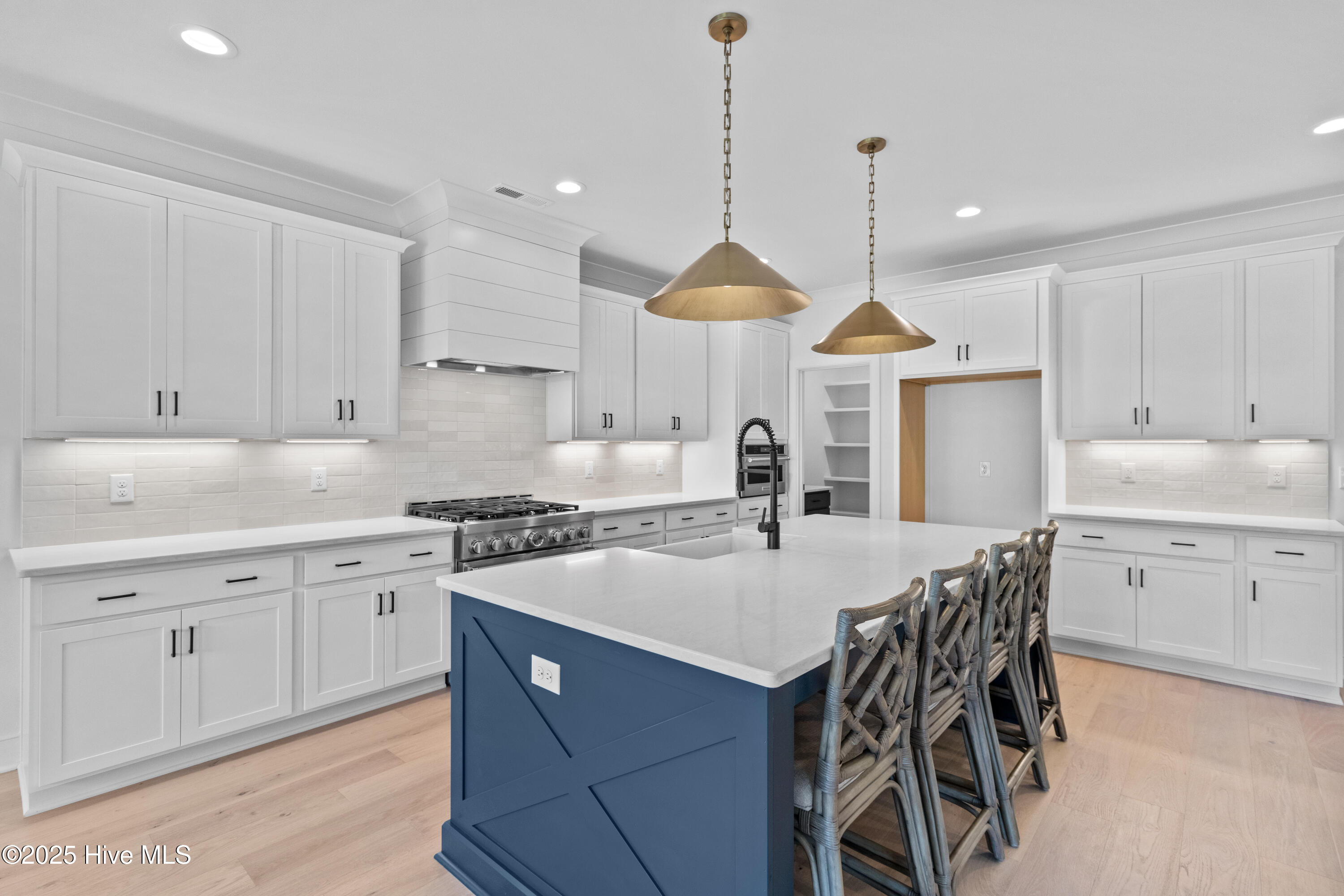 Large island with sink, dish washer, and seating