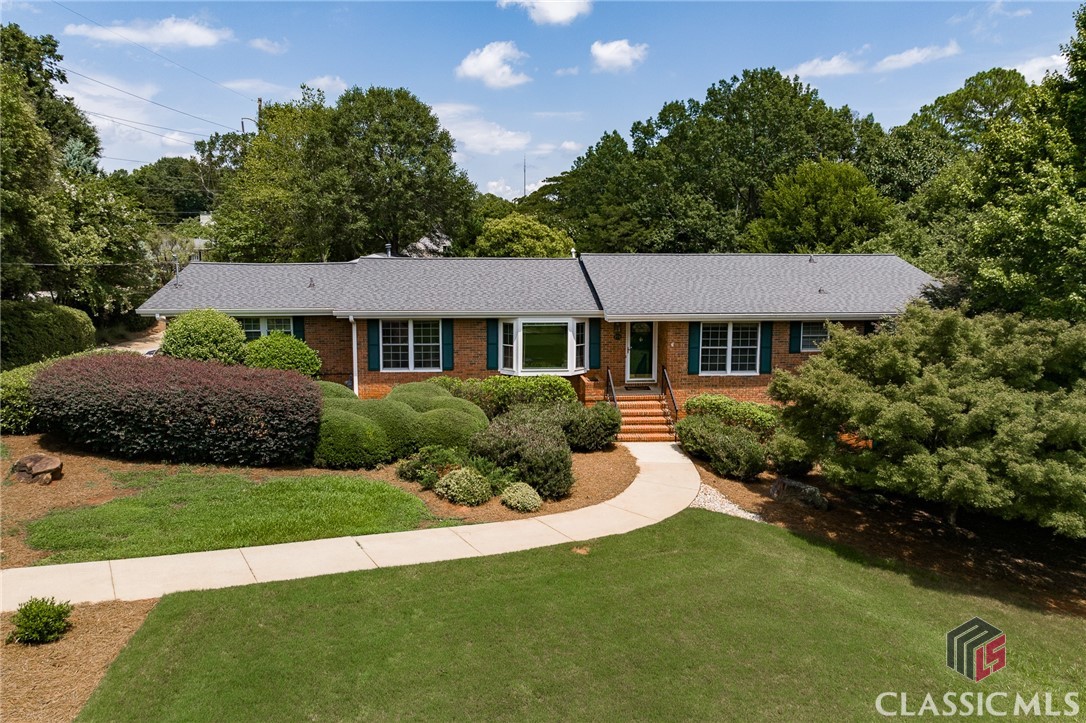 Welcome to 275 Woodward Way, a charming all-brick ranch nestled in the highly sought-after Glenwood neighborhood in Five Points. Situated on an expansive corner lot spanning over an acre, this home offers endless possibilities.Step through the front door and be greeted by a classic floor plan. To the left, you'll find a formal living room with a stunning bay window, followed by a cozy sitting room that flows into the kitchen and dining area. While the home is move-in ready, it also presents ample opportunities for updates and renovations. The neutral color palette and white cabinetry provide a blank canvas for your imagination. To the left of the kitchen, a bright and spacious family room awaits, complete with a half bath, laundry room, and butler's pantry. Featuring a vaulted ceiling and skylights, this inviting space is perfect for relaxing by the fireplace in cooler months or enjoying the picturesque backyard in the summer. Sliding doors lead to a recently refinished expansive deck, ideal for outdoor lounging. The backyard is a true oasis, featuring a flagstone patio, manicured lawn, and endless possibilities for adding a pool or ADU.On the right side of the house, you'll discover a well-appointed main bedroom with an ensuite bathroom, along with two additional bedrooms sharing a Jack and Jill bathroom. While the main level offers everything you need for comfortable living, the terrace level adds extra flexibility. Here, you'll find an additional bedroom and full bath, as well as a cozy living room with built-ins. With its own exterior access, this level could serve as a private apartment for guests or a rentable Airbnb.The home also includes an attached two-car garage with ample storage space.Meticulously cared for by the current owners, this home is in excellent condition with updated systems ready for many more years of service. With a competitive price that allows for customization and a prime location, don't miss the chance to make 275 Woodward Way your own. Schedule a viewing today!