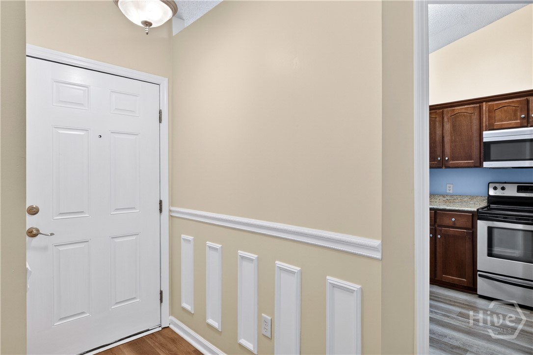 Looking at the front door with the kitchen on your right