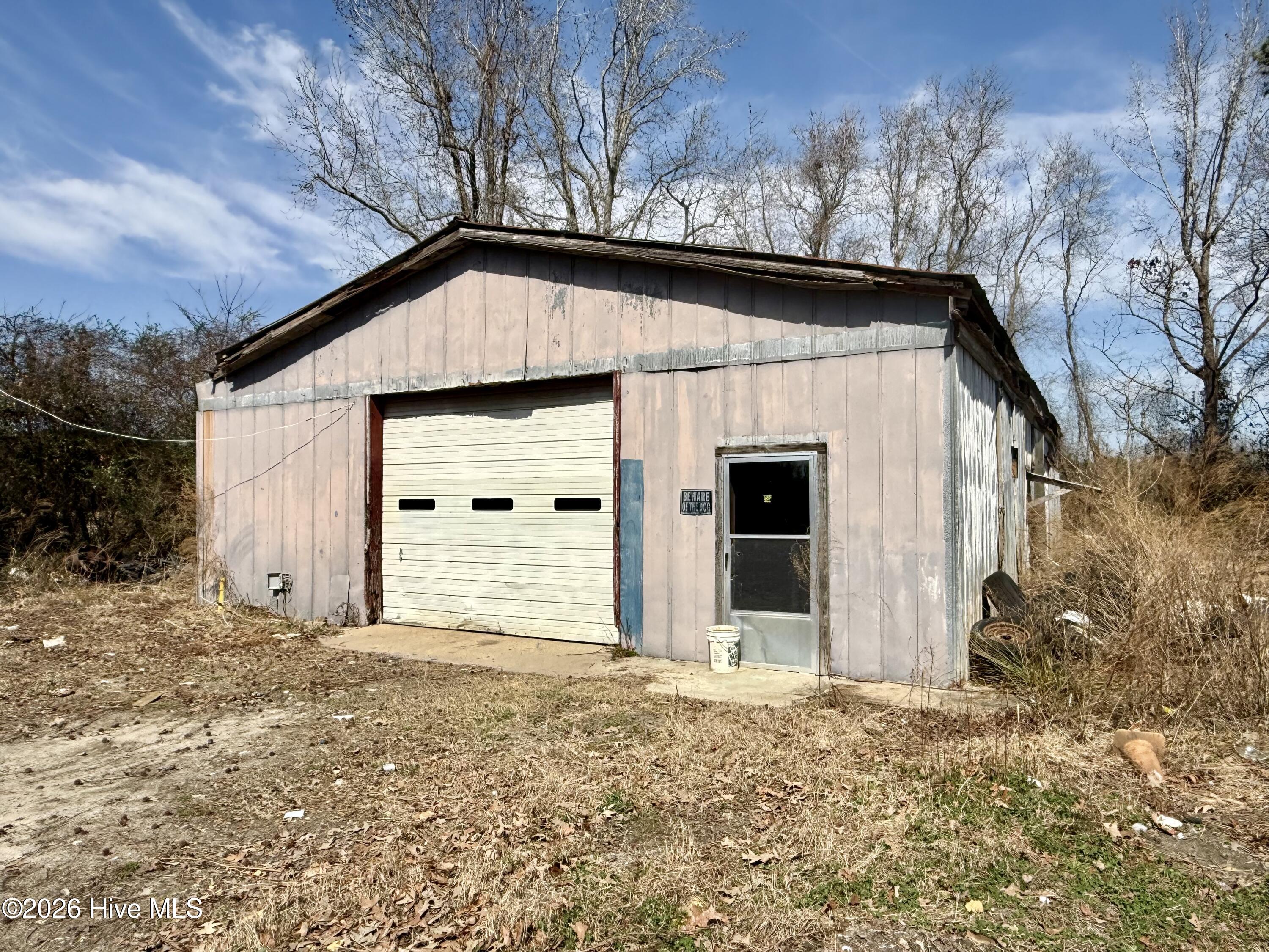 Looking for a commercial space with potential to launch or expand your business? This warehouse/mechanics storage yard is ready for its next chapter and new ownership. With a long history of use as a mechanic and vehicle storage yard, this property offers a great opportunity for entrepreneurs, hobbyists, or anyone in need of workspace and storage.The main outbuilding sits on a solid concrete slab and is currently connected to both electricity and water. While the structure does require repairs--including roof leaks and areas of termite and wood rot damage--it still offers a functional foundation for those willing to bring their vision and improvements to life.The yard area provides ample space but will require cleanup, giving buyers the chance to customize the property to suit their needs. Whether you're looking for a project property, storage facility, workshop space, or small business location, the possibilities here are worth exploring.Property is being sold as-is, with any personal property conveying with the sale. Buyers are responsible for conducting any environmental site assessments if desired.Bring your ideas and see the potential this commercial property has to offer!
