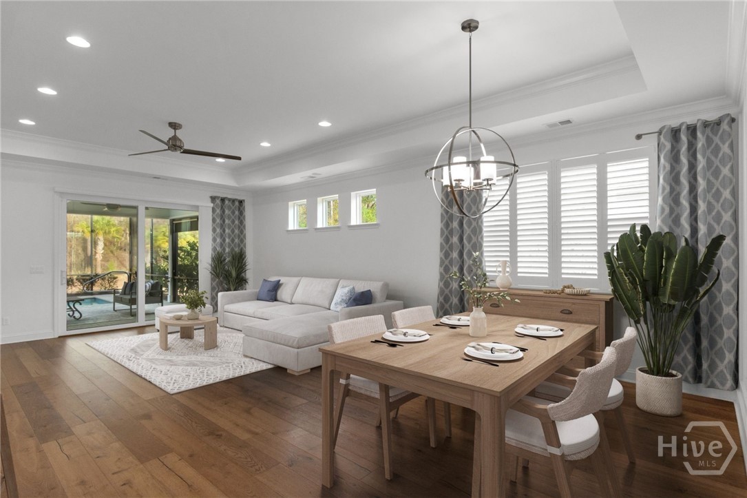 Virtually Staged - The dining room and living room extend to the sliding glass door with pool views