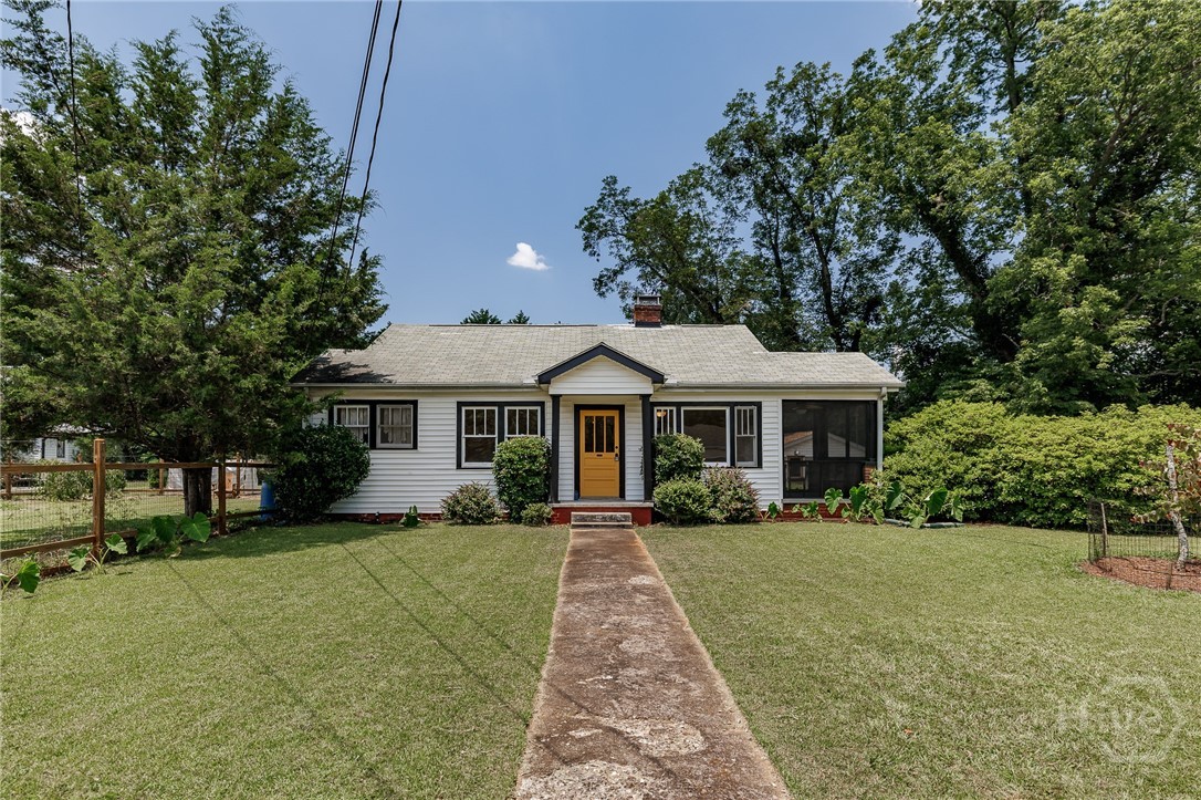 Don't miss this adorable, renovated cottage on the Eastside! A perfect blend of yesteryear's charm with original hardwood flooring throughout, arched casement doorways, masonry fireplace, plus a fully renovated kitchen and bath! Every room is flooded with natural lighting cast from double windows. The living room has a cozy feel and has access to a private screened porch. Kitchen features stainless steel appliances, granite countertops, and multiple windows with views of the fenced garden area. Two bedrooms share a central, updated bathroom, and there is a spacious laundry area. Many plantings have been added throughout the yard for privacy and curb appeal. Detached garage with new roof has a workshop and storage area. Located just about as close as one can be to the UGA Veterinary Teaching Hospital, new Kroger, and Eastside dining options.