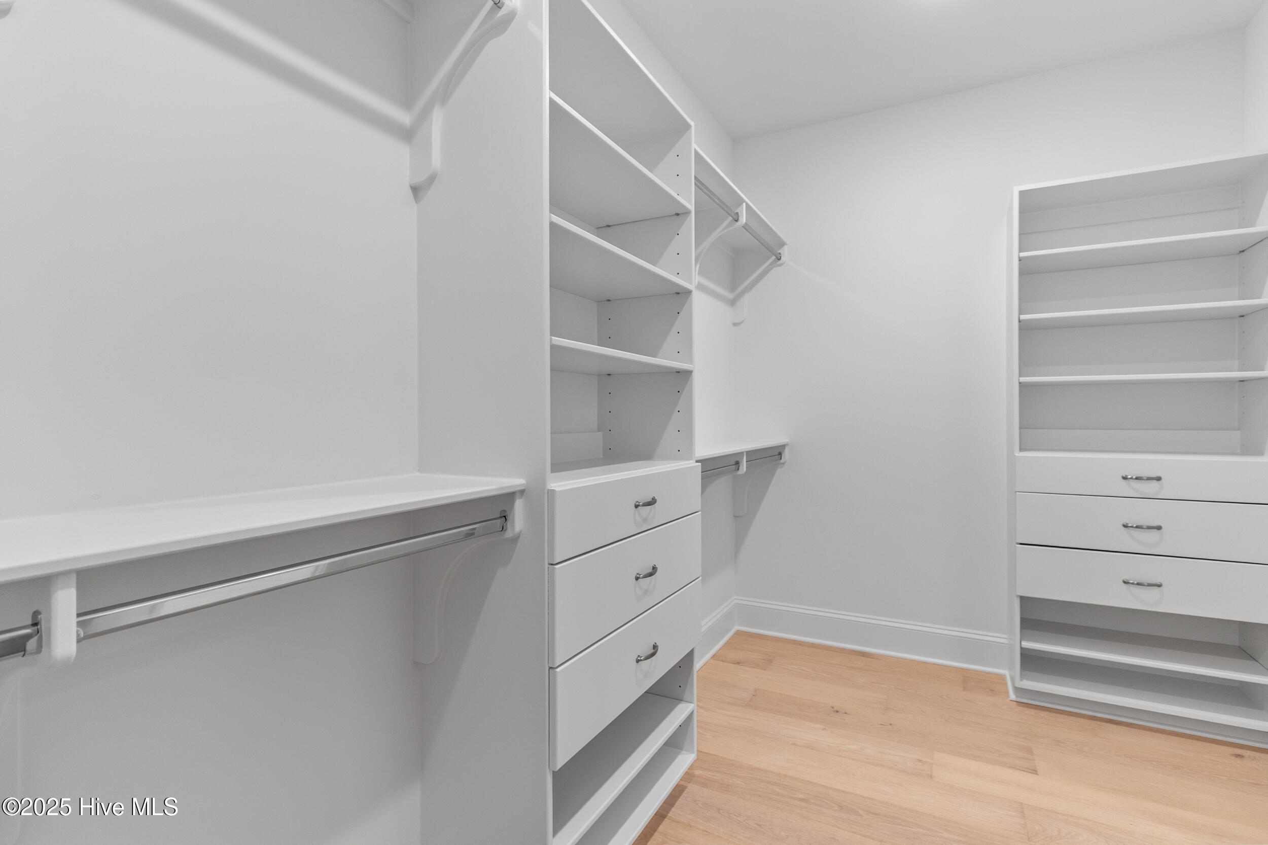 Primary walk-in closet with built-ins