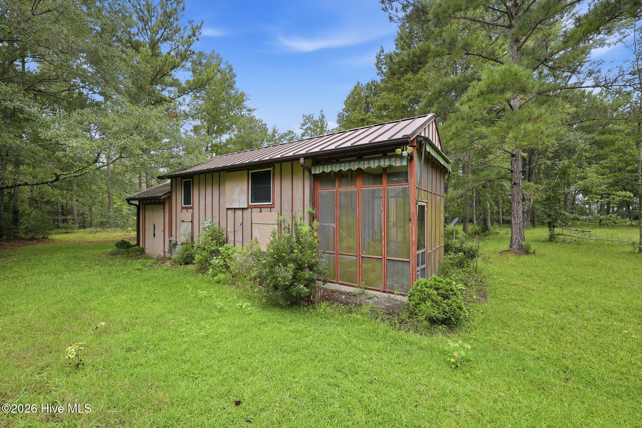 Sublime - stand in the middle of this 14.8 acres of treed, grassy meadow and see the river and hear the peaceful sounds of nature. Property is gently rolling, with trees throughout.  It's not a forest and not overgrown. There is a rustic cabin waiting for weekend visits. Electricity and water are already in place and connected to the one bedroom cabin.  Owner's intent was to use this dwelling for temporary living while a larger full-time home was built.  They just never accomplished getting that final home constructed.  That leaves so much room for your own imagination to take over, locate and build a customized home or homes in this very generous acreage. the waterfront awaits.