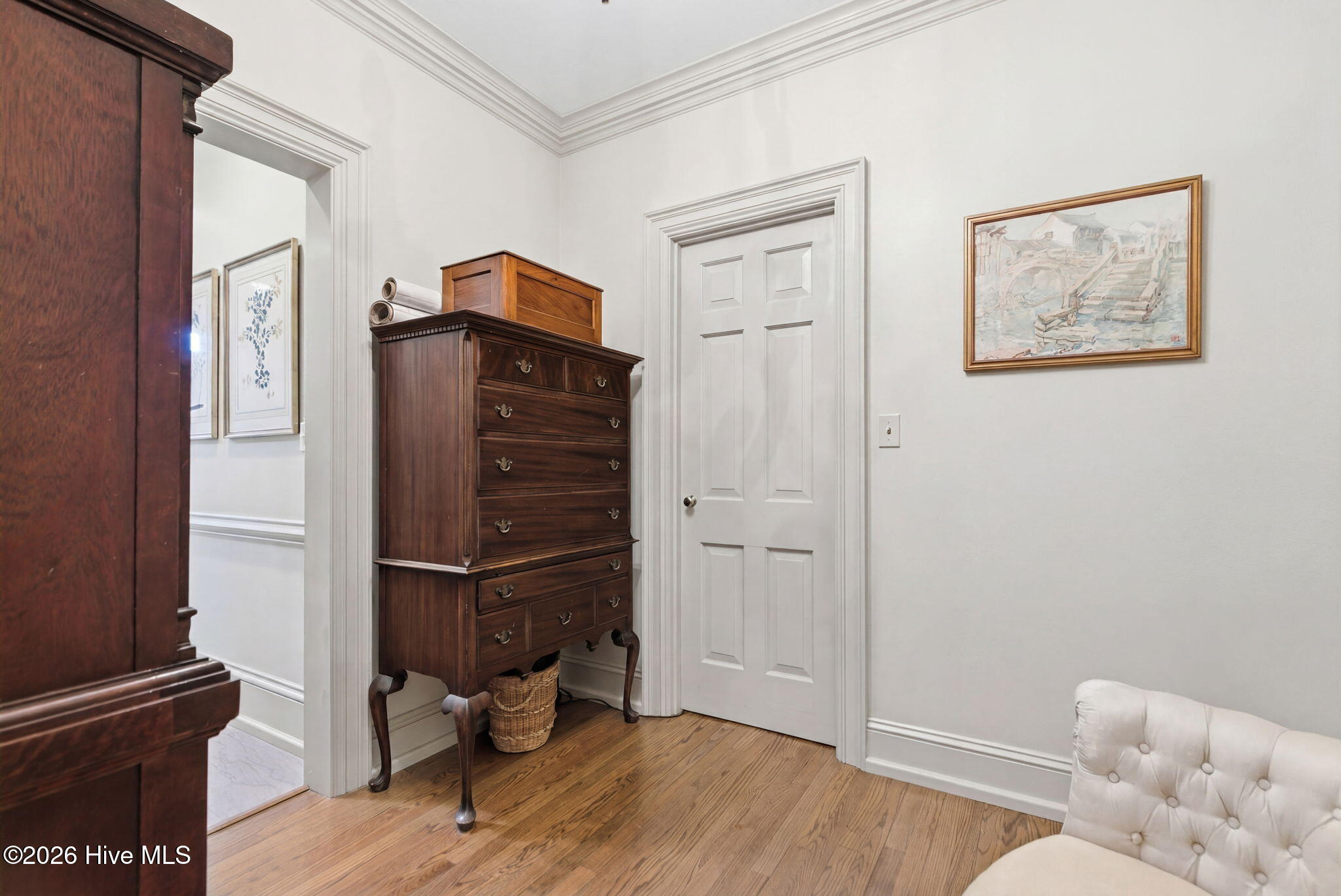Primary suite 2nd dressing room with walk-in closet and built-in cabinetry.